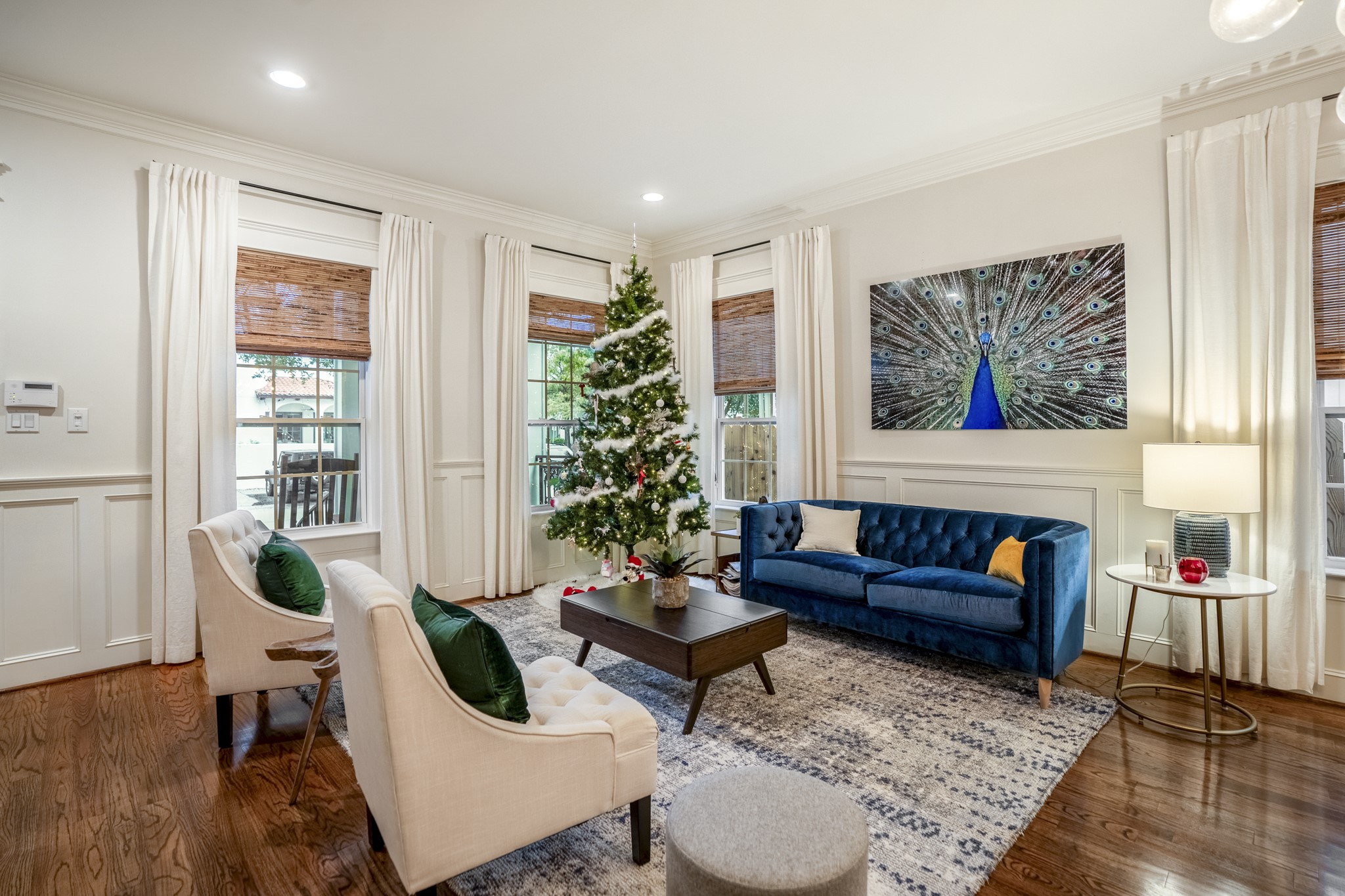 Multipe windows in this living room for ample natural light. Custom blinds and curtains convey with the home. Multipe windows in this living room for ample natural light. Custom blinds and curtains convey with the home.