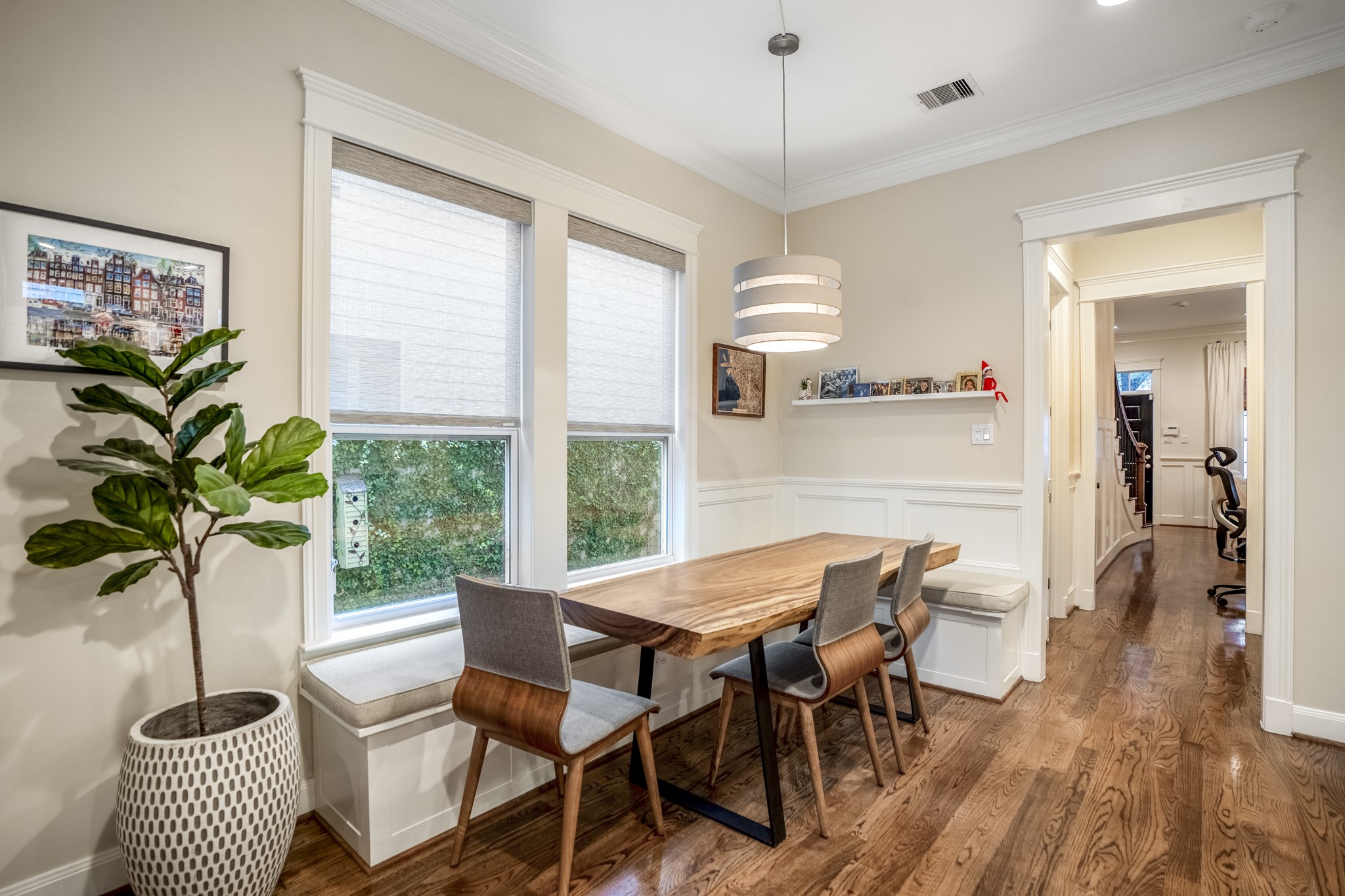 Custom wood paneling and built-in bench seating in this breakfast nook adjacent to the island kitchen.