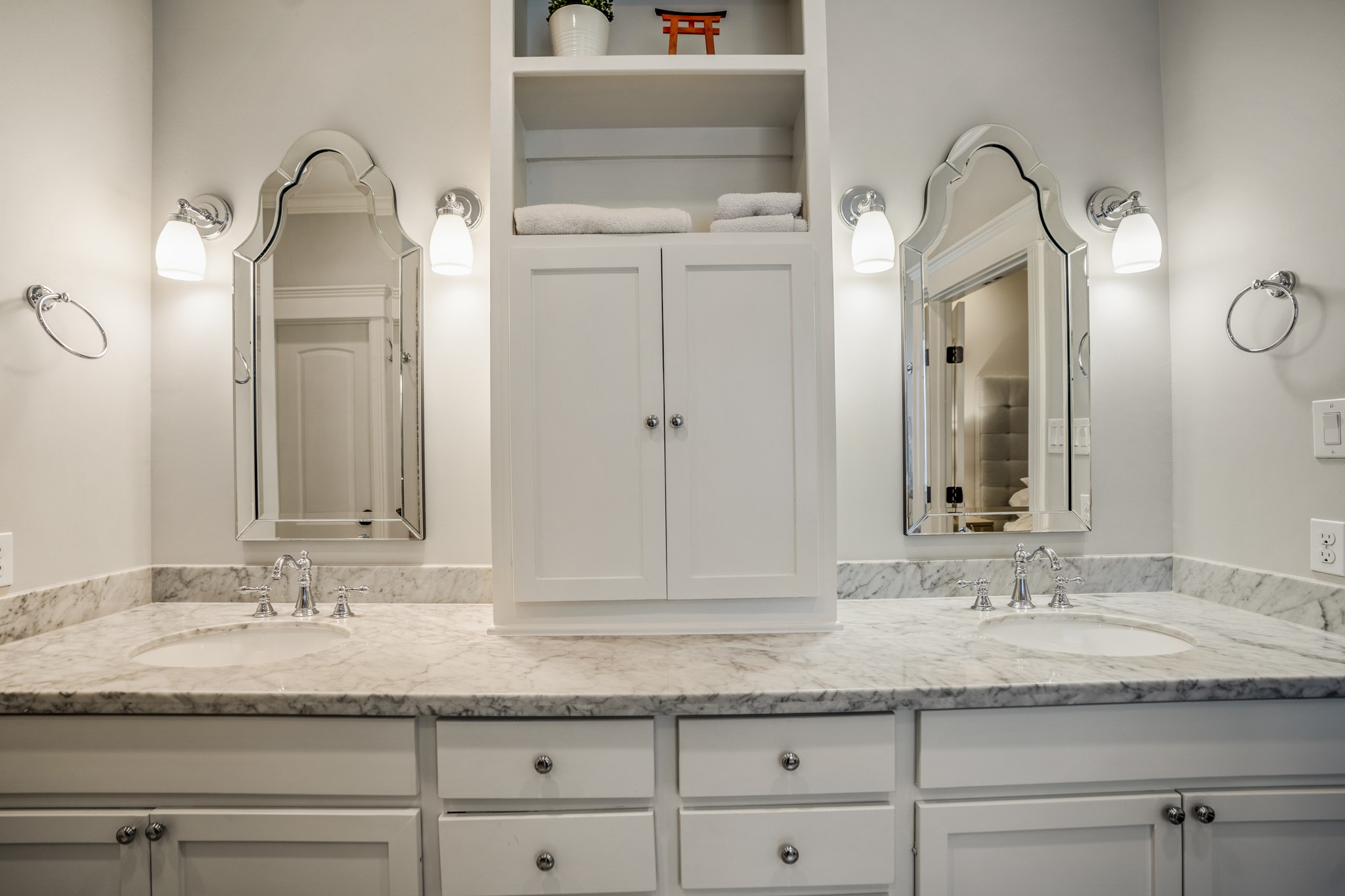 Dual vanities and plenty of cabinets for storage.