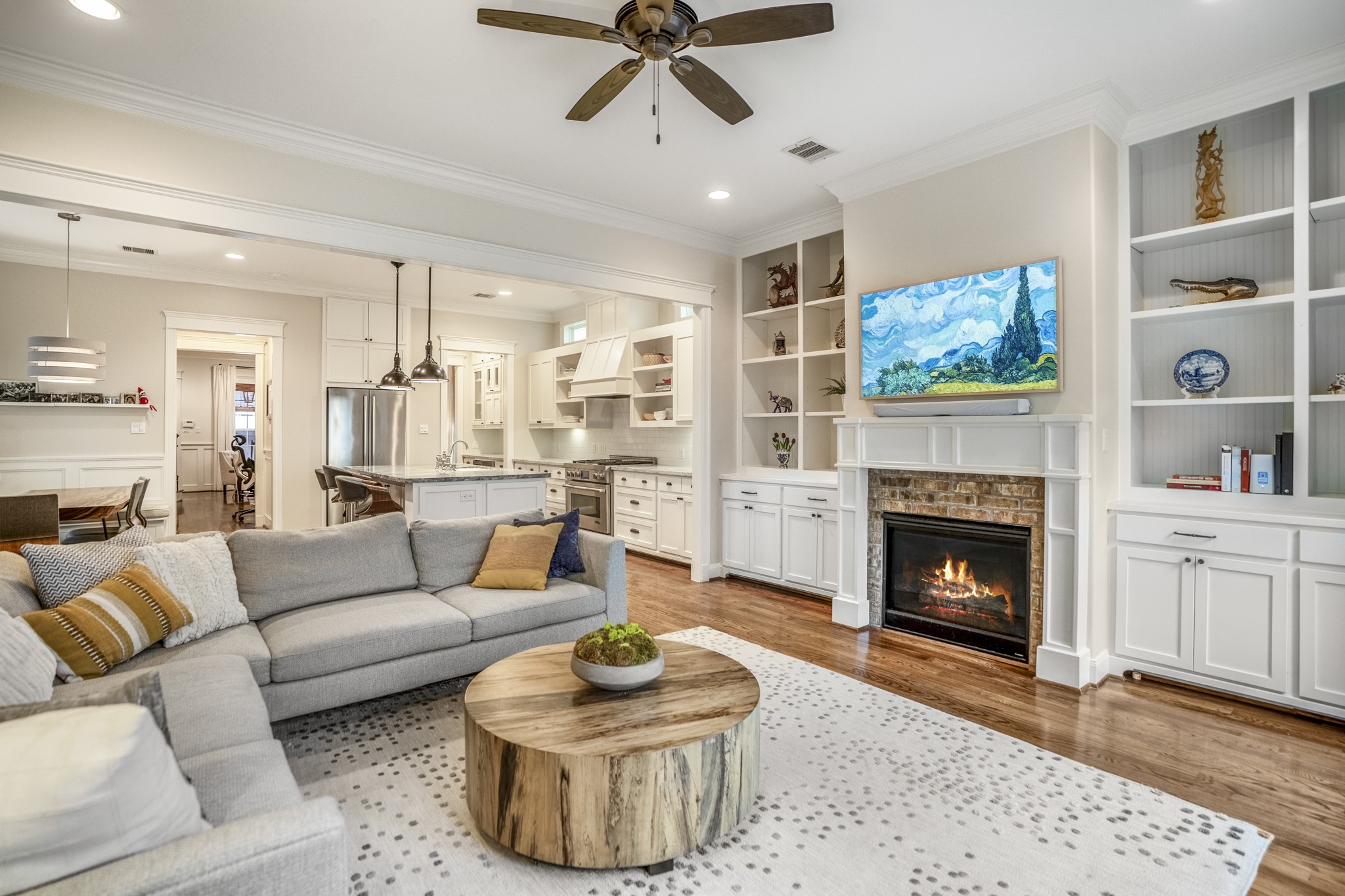 Another view of this living room space with recessed lighting and a ceiling fan for maximum comfort.