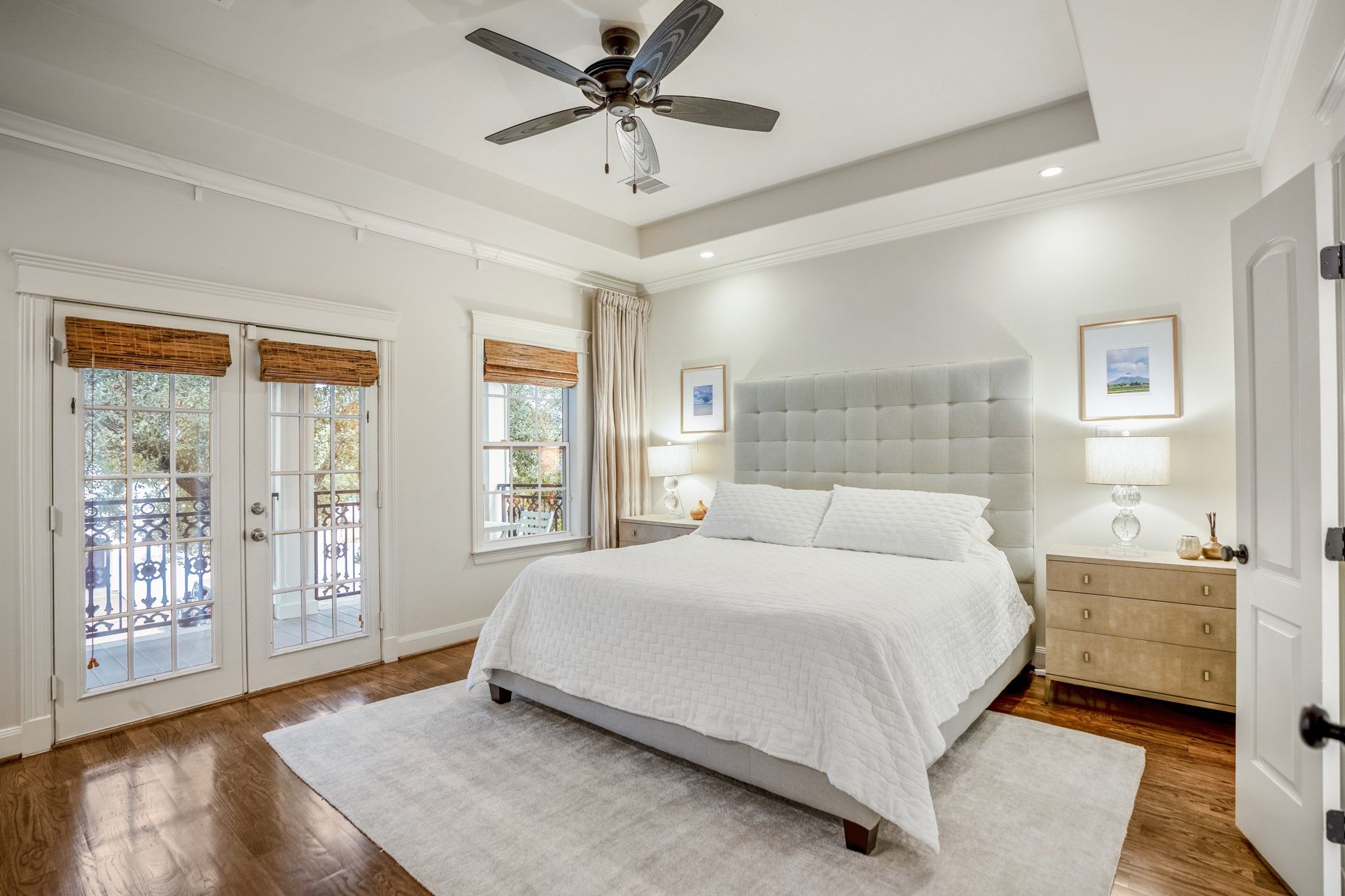 Welcome inside your beautiful primary bedroom with double French doors that lead to a spacious covered balcony overlooking your majestic front yard trees.