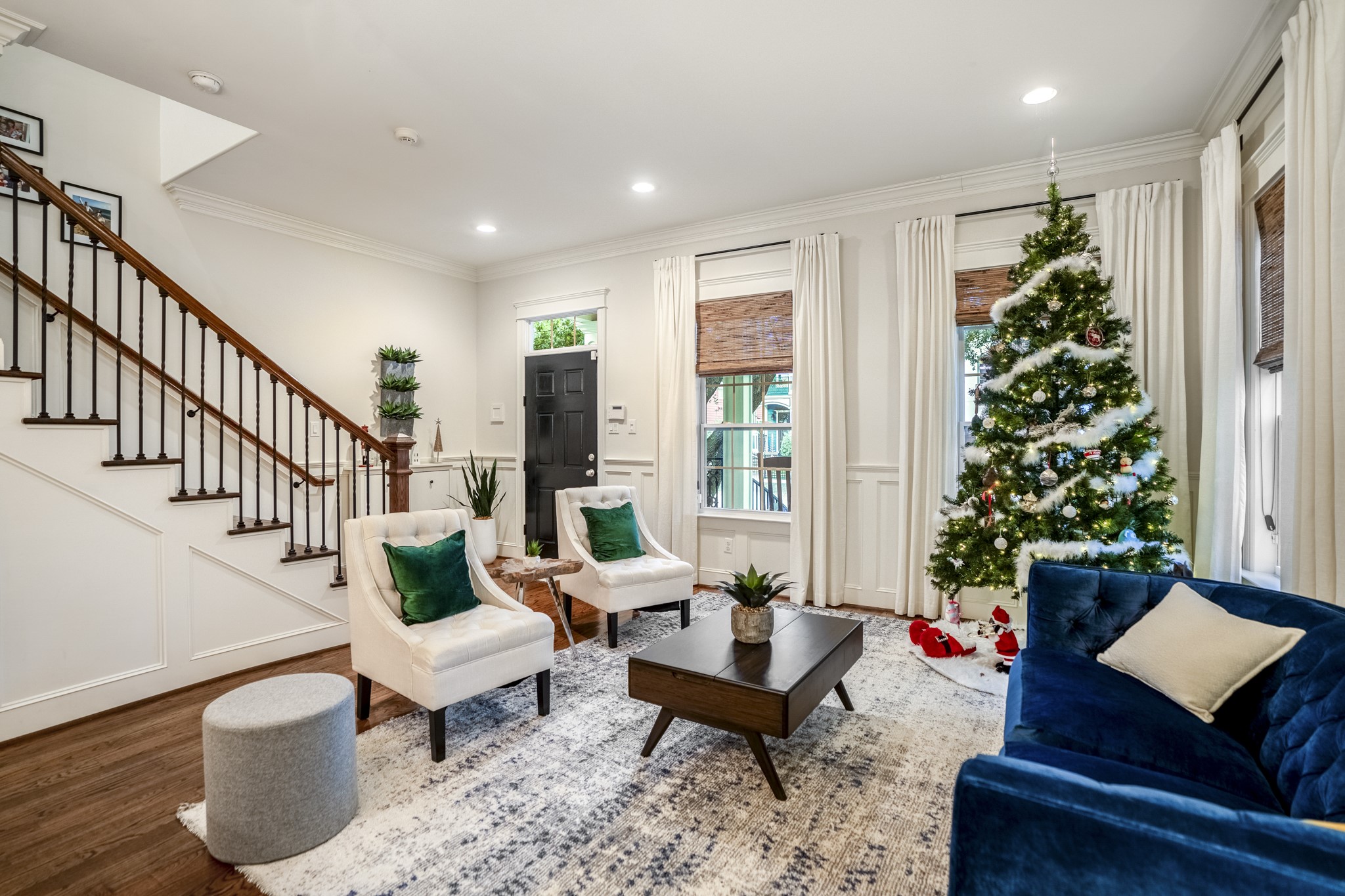 Reverse view of this living room that features four large windows for ample natural light. Reverse view of this living room that features four large windows for ample natural light.