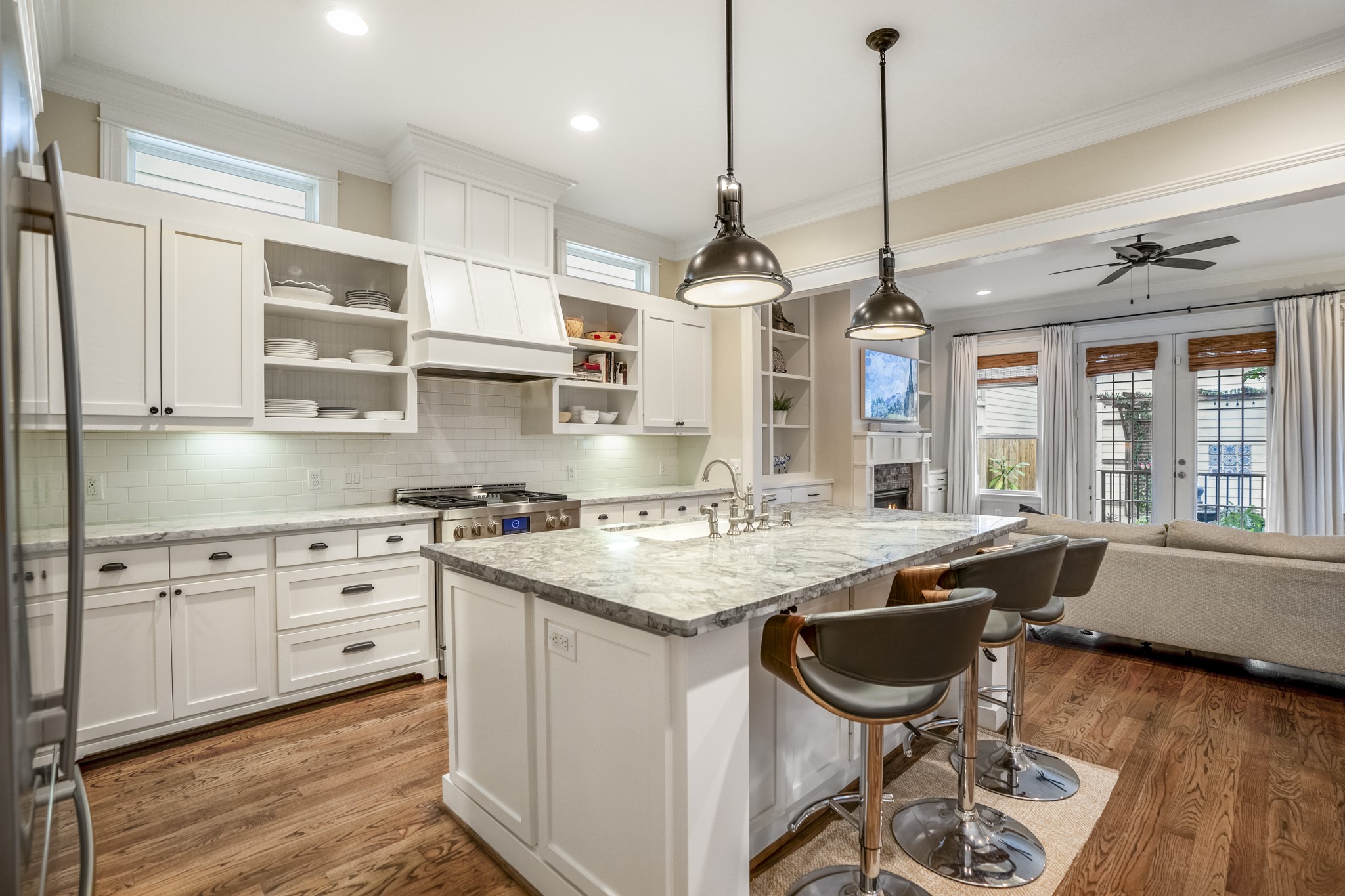 Notice two peek-a-boo windows above the kitchen cabinets for natural light. This space flows right into your family room.