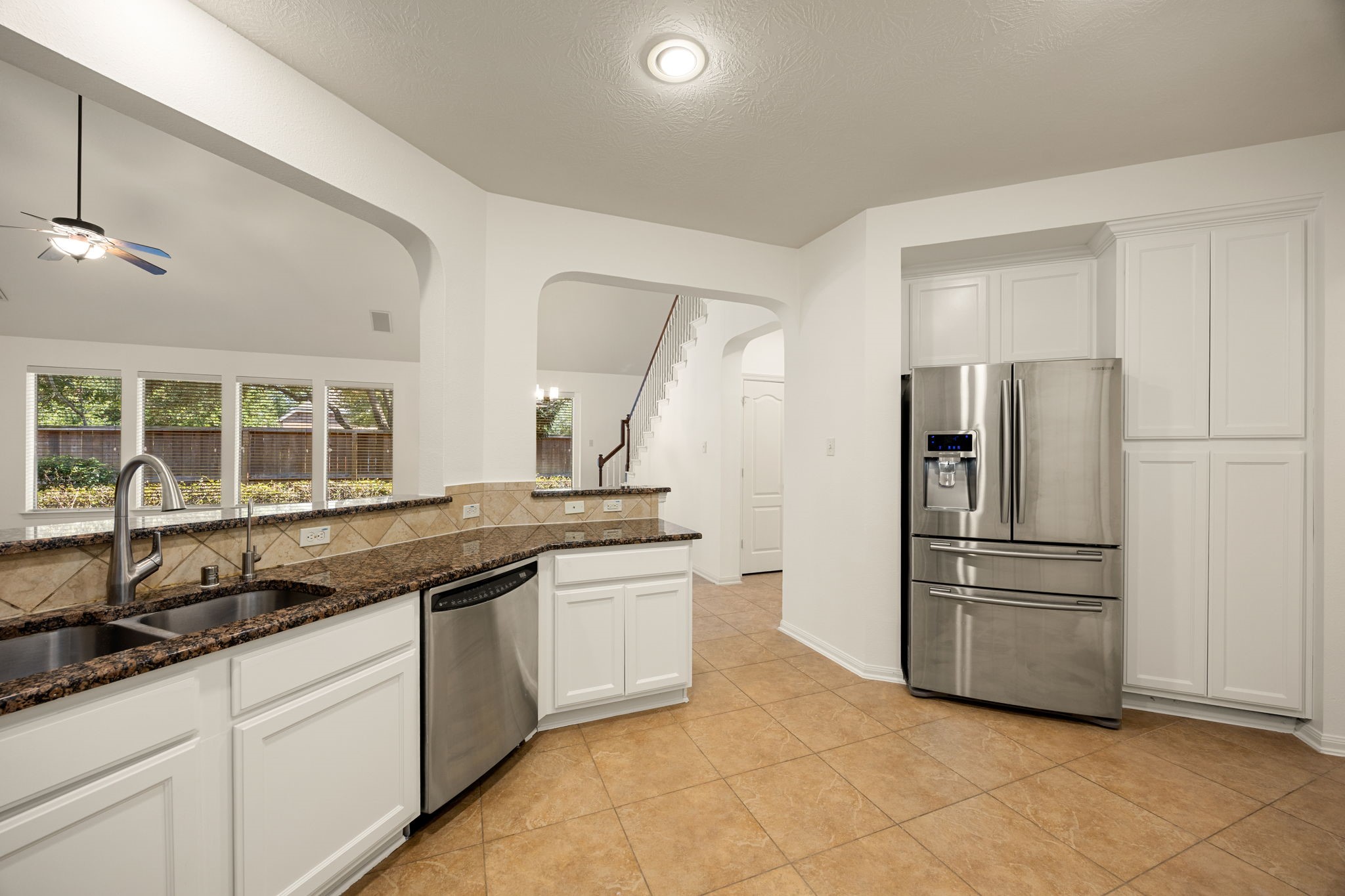 Premium stainless steel appliances take center stage in this final kitchen angle, seamlessly blending modern efficiency with the home's bright, open aesthetic.