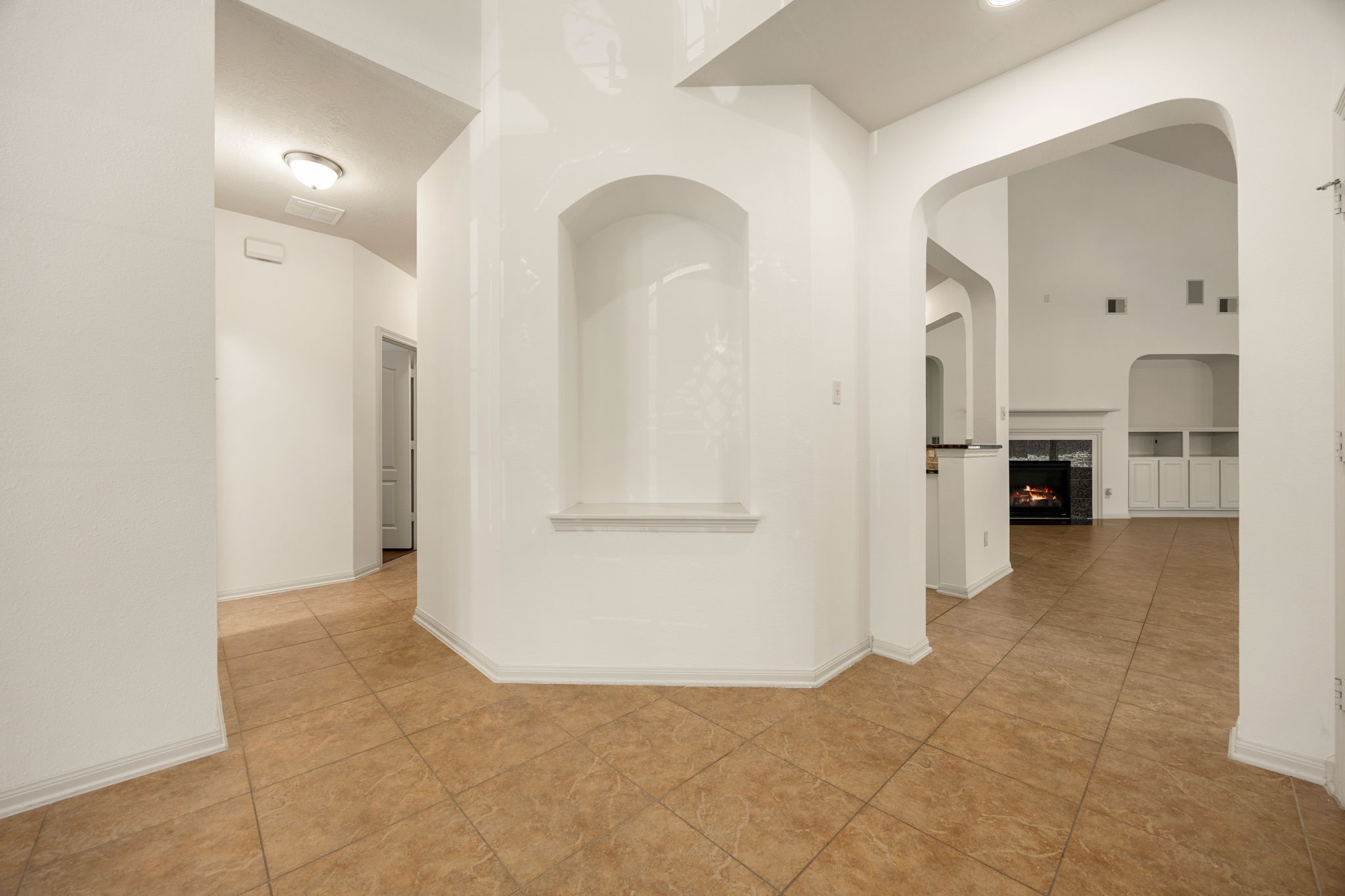 This central architectural alcove serves as a sophisticated focal point, perfect for showcasing prized artwork or a favorite sculpture beneath the subtle glow of overhead lighting. This central architectural alcove serves as a sophisticated focal point, perfect for showcasing prized artwork or a favorite sculpture beneath the subtle glow of overhead lighting.