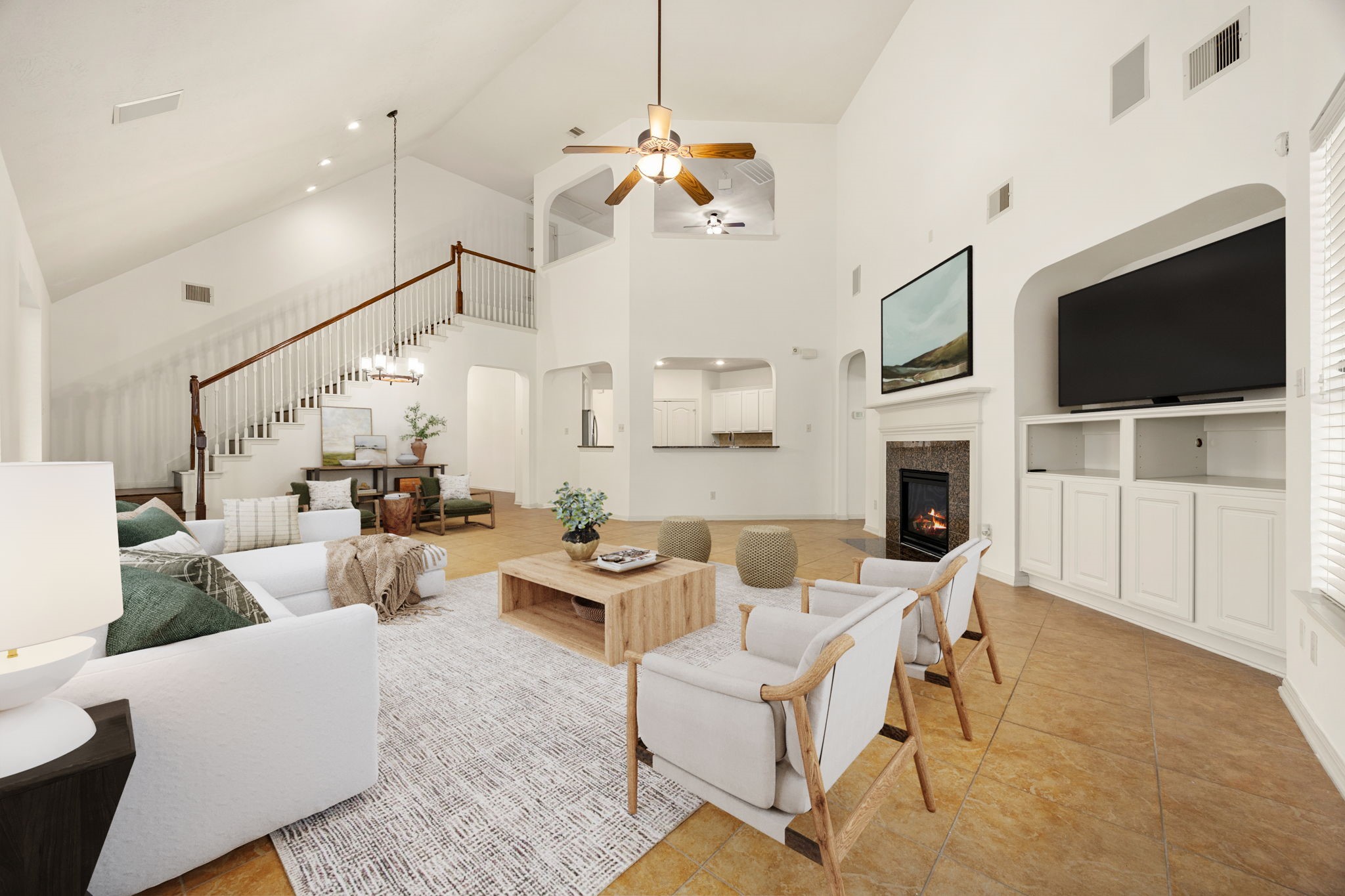 This alternate view of the expansive family room reveals the true grandeur of the home's open-concept design, anchored by a soaring two-story ceiling and a sweeping staircase. *Virtually Staged