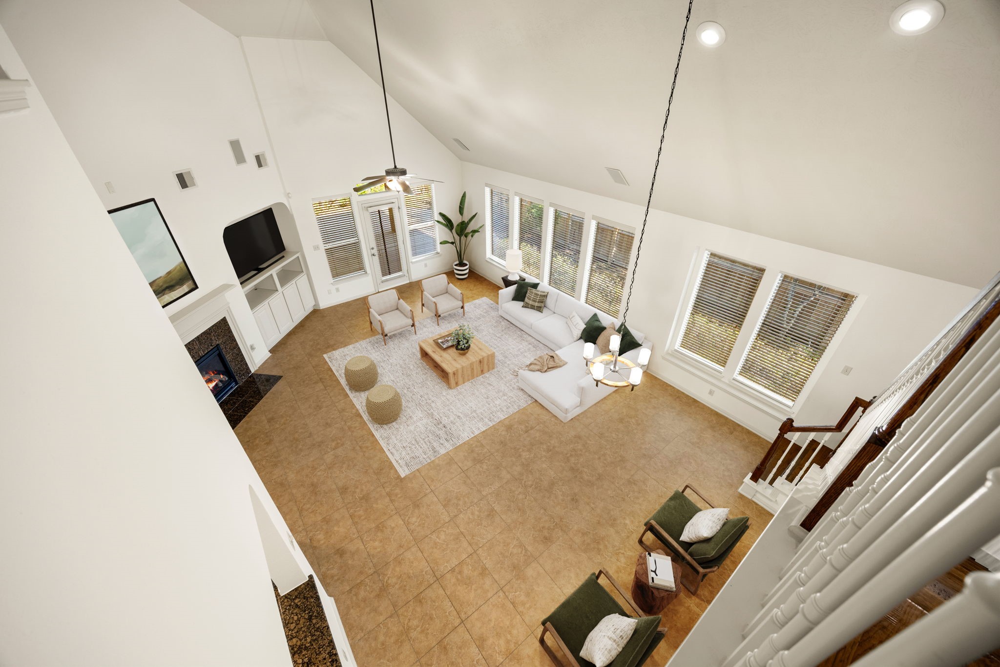 This stunning bird's-eye view from the upper balcony highlights the grand proportions and impressive architectural scale of the main living space. *Virtually Staged
