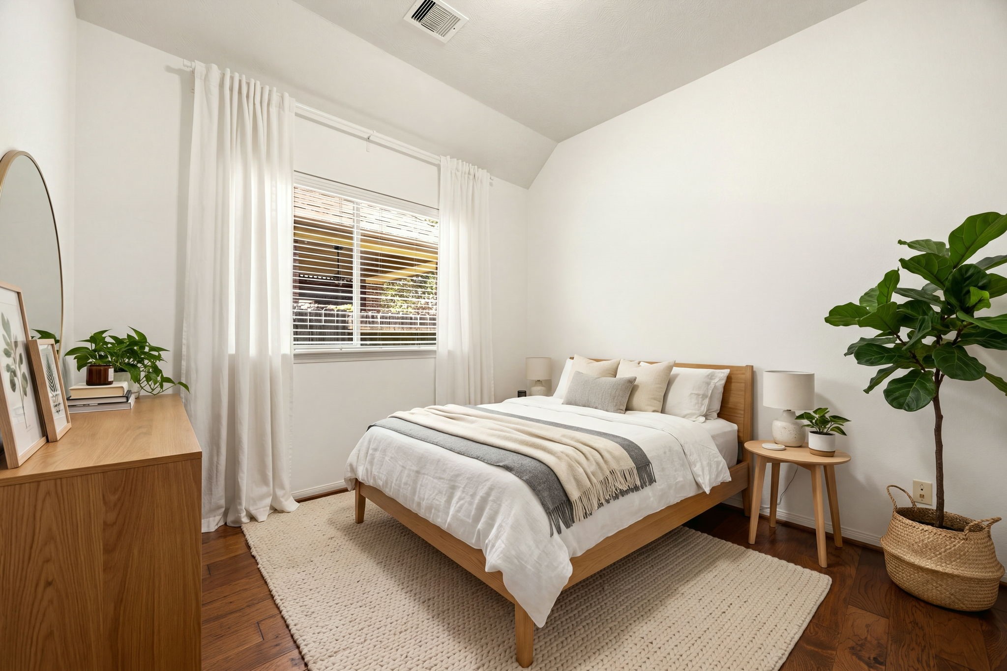 Offering a peaceful setting filled with natural light, this additional secondary bedroom stands out with its grand vaulted ceiling and warm hardwood flooring. A large window provides a beautiful view to the outside while keeping the room feeling exceptionally bright and airy. *Virtually Staged