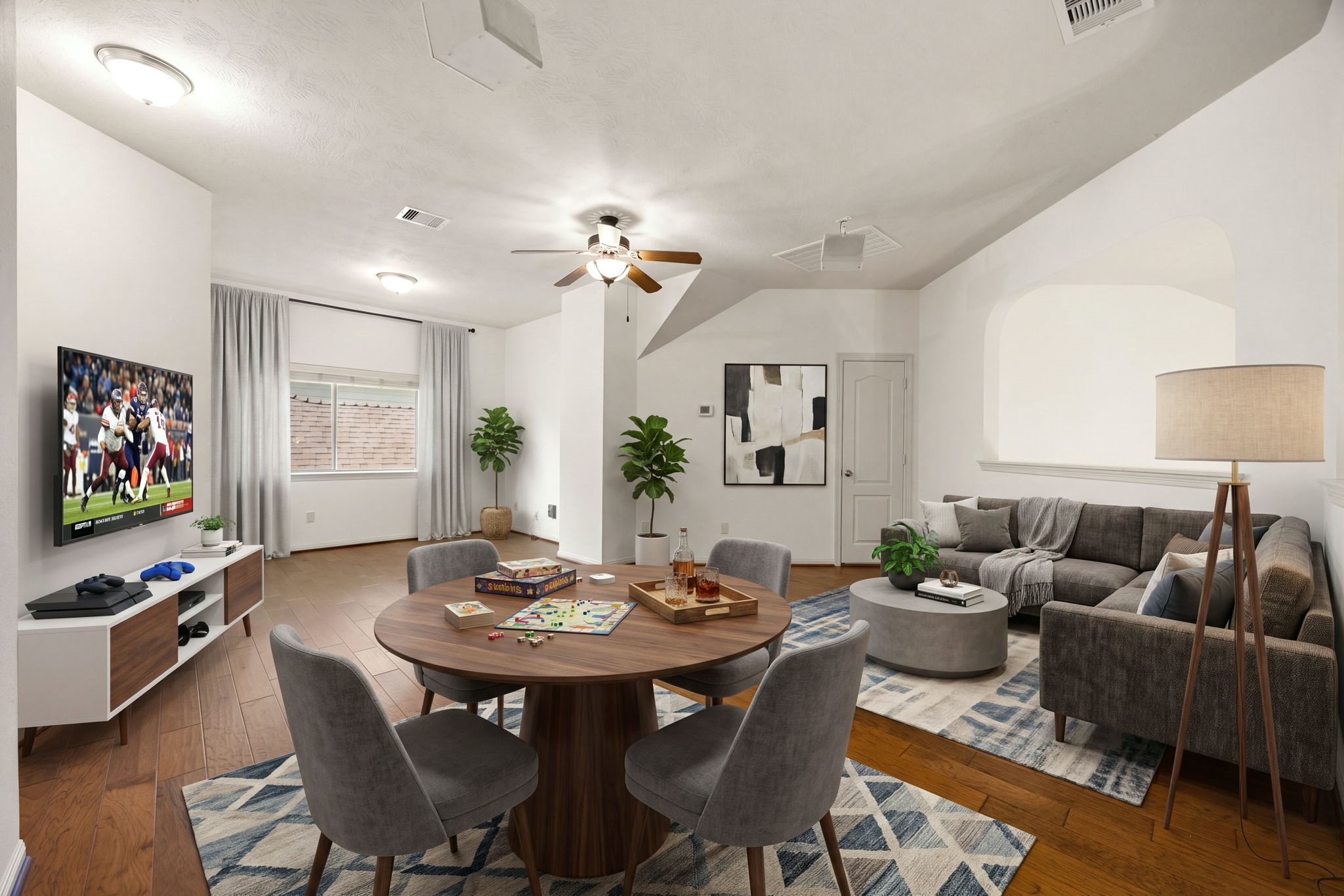 Located upstairs, this expansive game room serves as the ultimate flexible entertainment hub, offering distinct zones for recreation and relaxation over continuous hardwood flooring. This large area could easily be sectioned off as an additional private secondary bedroom suite, complete with its own full bathroom located right on the second floor. *Virtually Staged