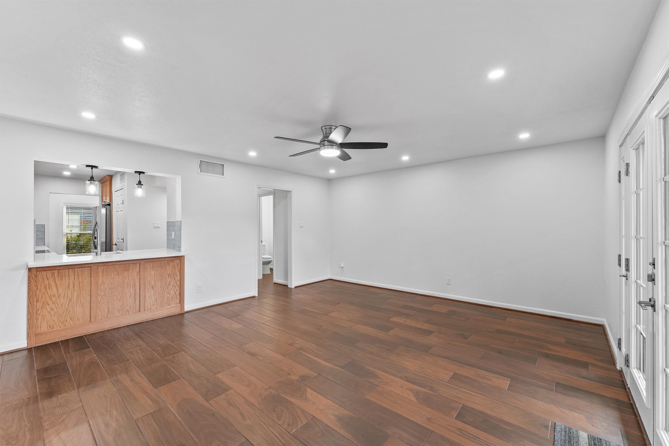 Spacious 17X16 living room with ceiling fan and recessed lighting