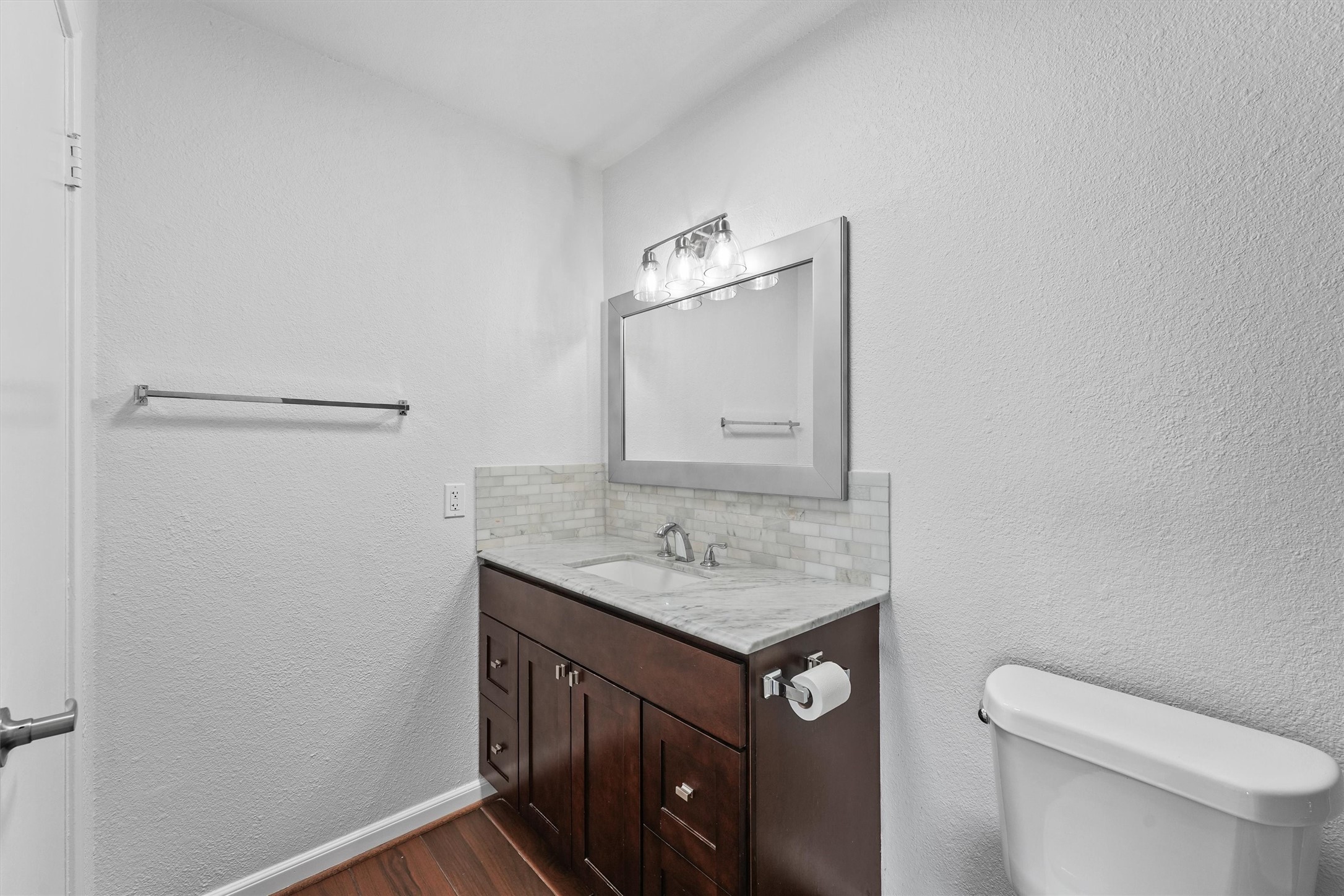 Secondary bathroom - totally renovated with updated countertop, light fixture and mirror, toilet, and tub/shower combo