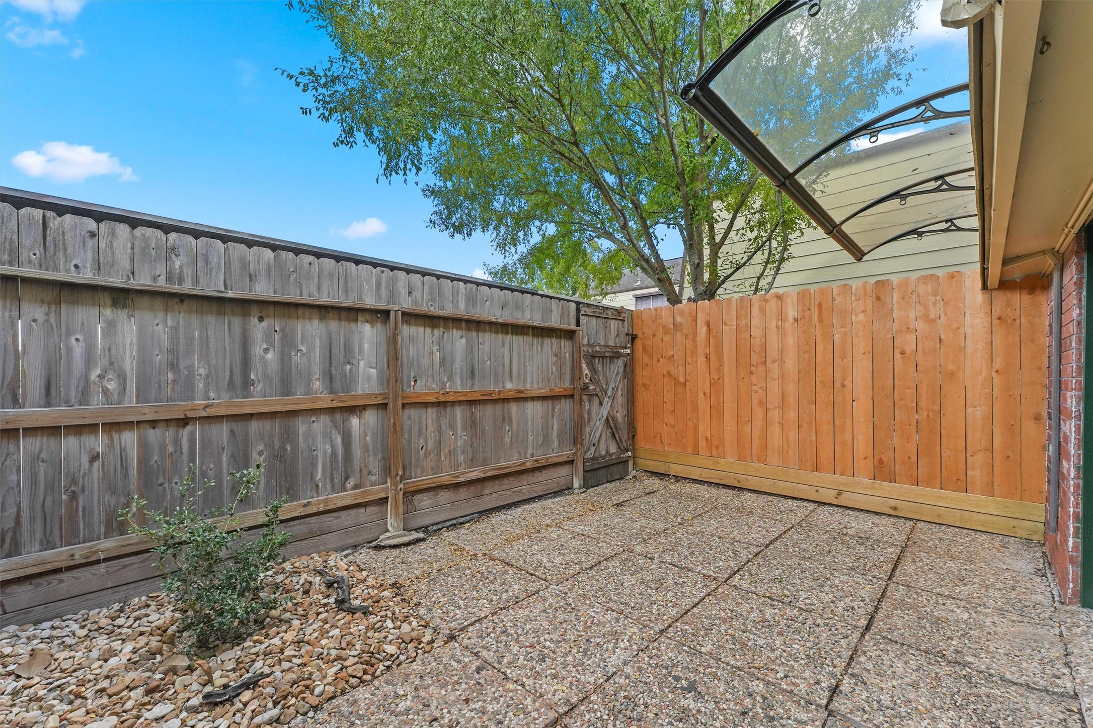 Private fenced in patio with awning