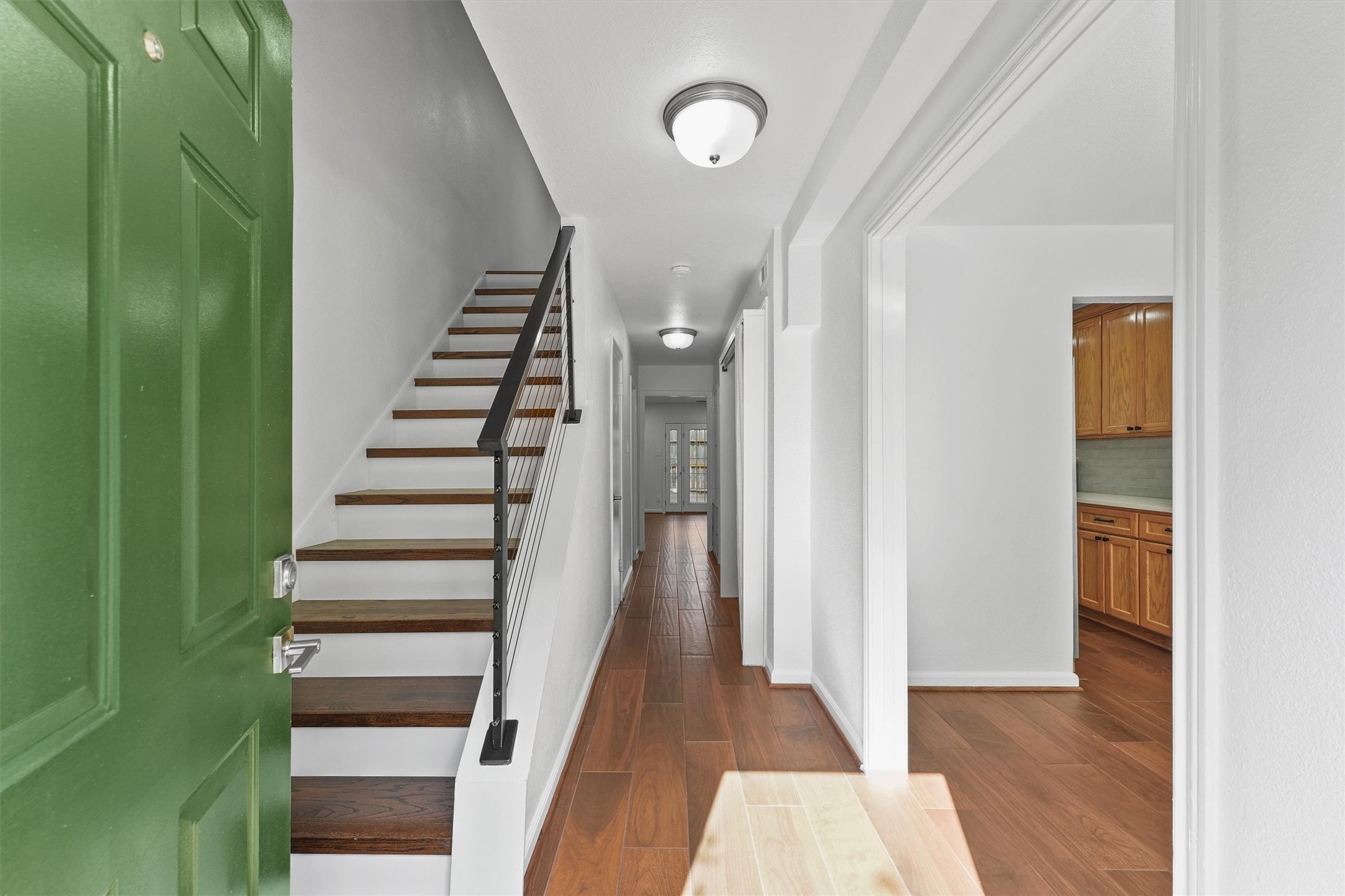 Wooden stairway leading to the 2nd floor with formal dining to the right