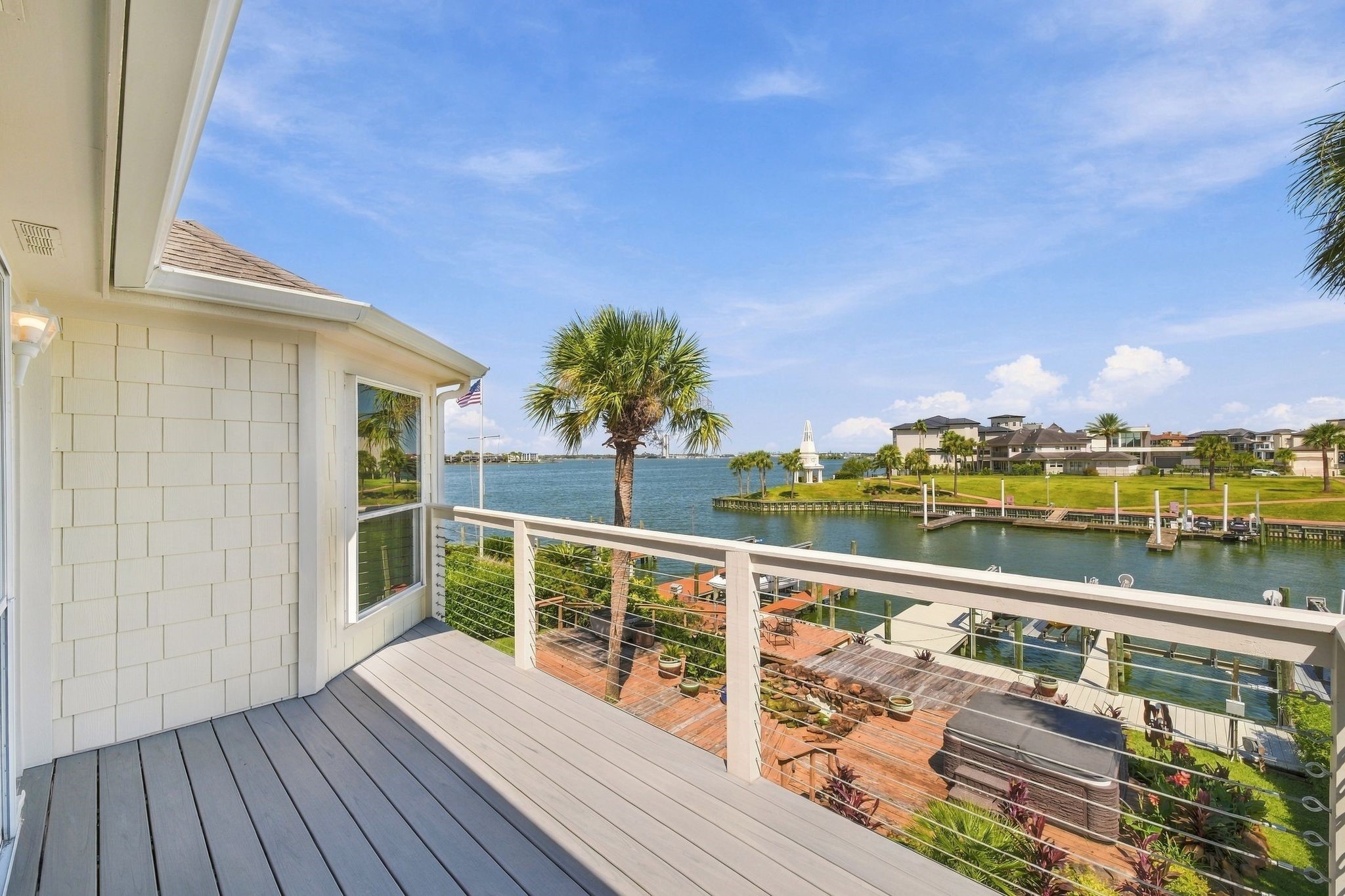 The balcony's modern cable railing keeps the lake views unobstructed.