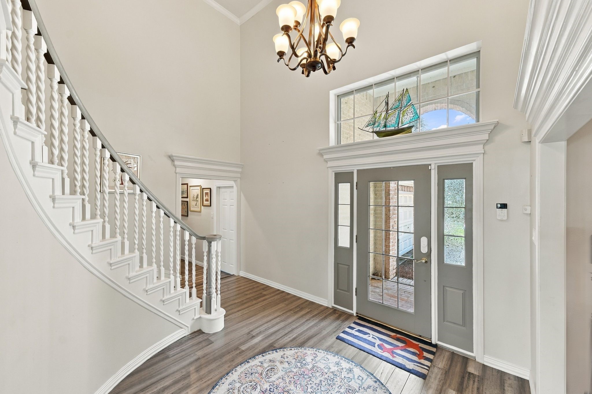 The grand entry has soaring high ceilings and a sweeping spiral staircase. The grand entry has soaring high ceilings and a sweeping spiral staircase.
