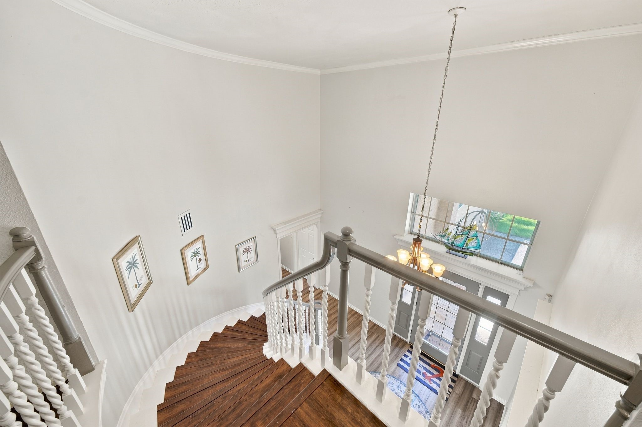The spiral staircase leads to the second floor and overlooks the grand entry below.