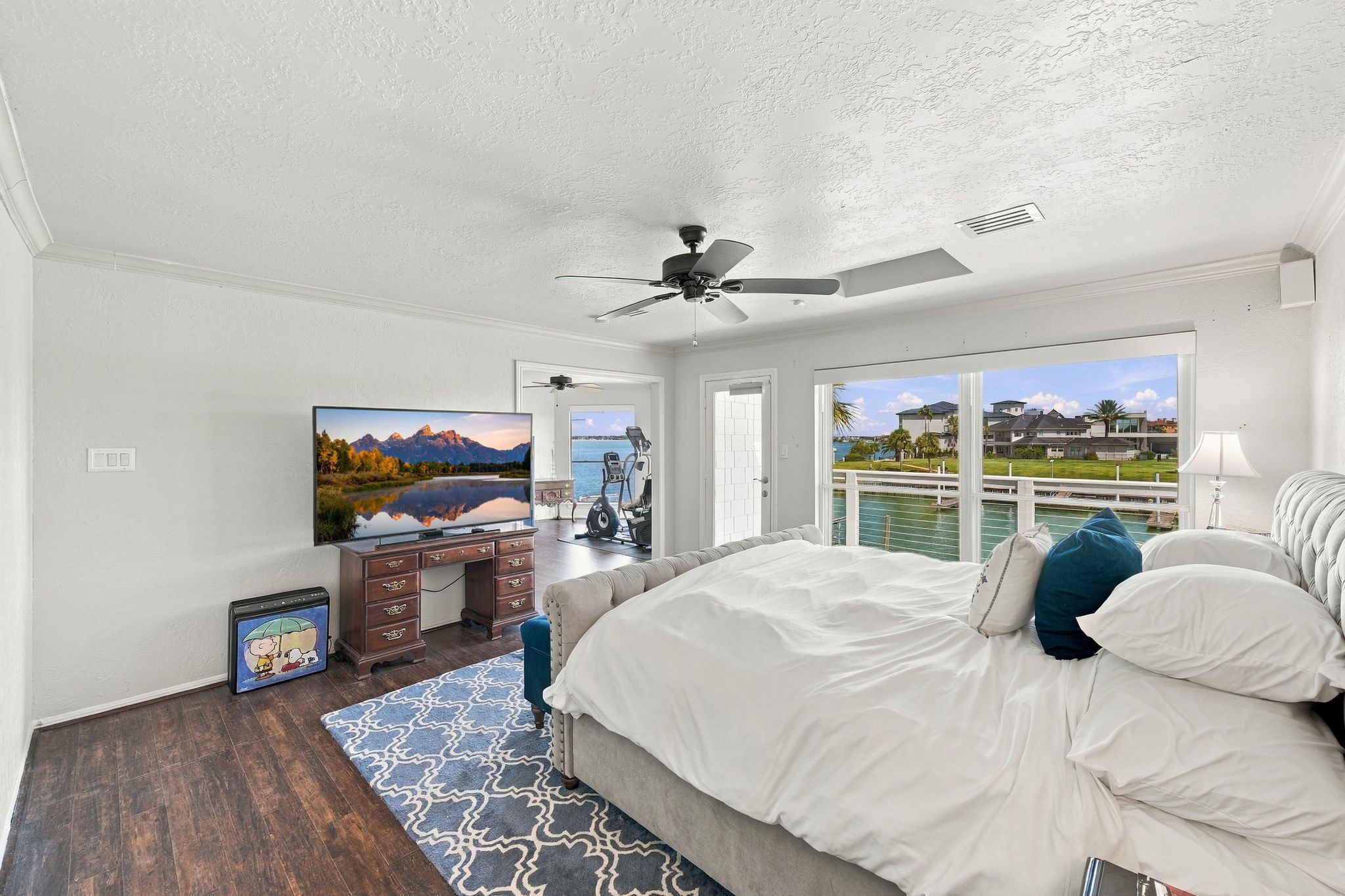 The primary bedroom has large windows with beautiful water views.