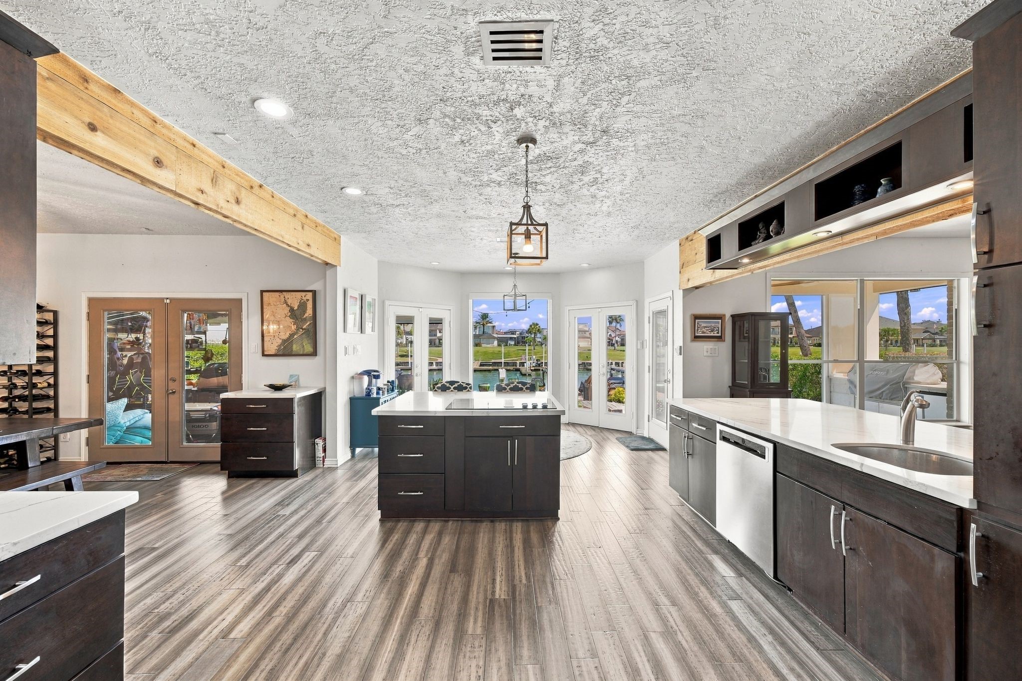 Stainless steel appliances and large windows fill the kitchen with abundant natural light.