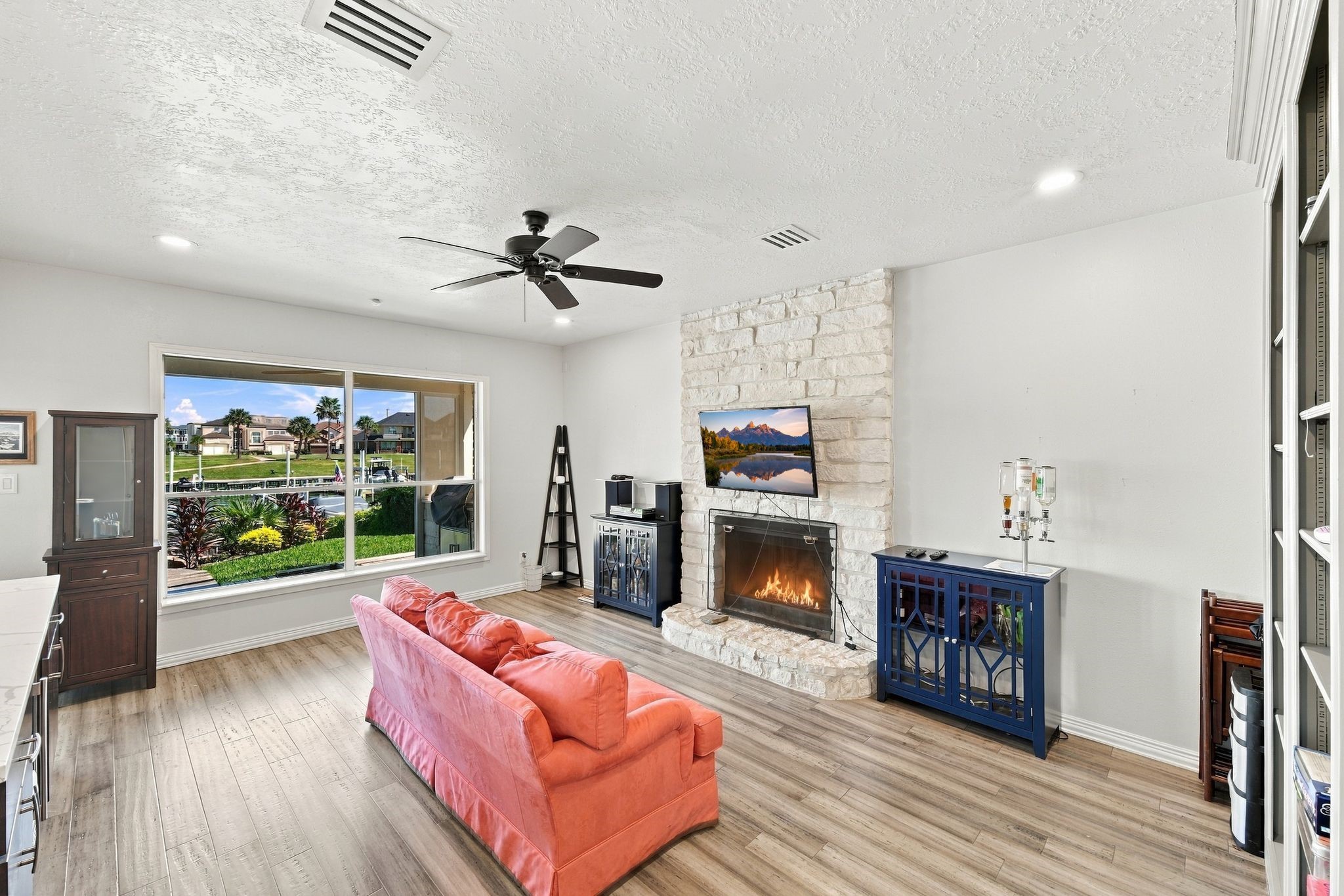 The den features a second wood-burning fireplace and a large picture window.