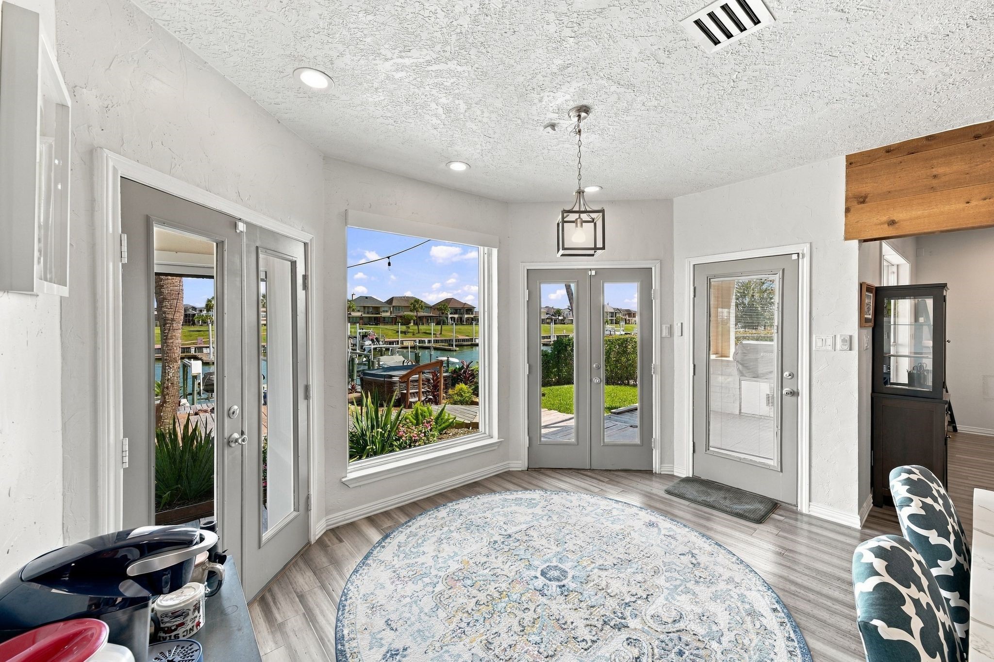 The breakfast nook has large windows and French doors to the backyard, filling the space with natural light.