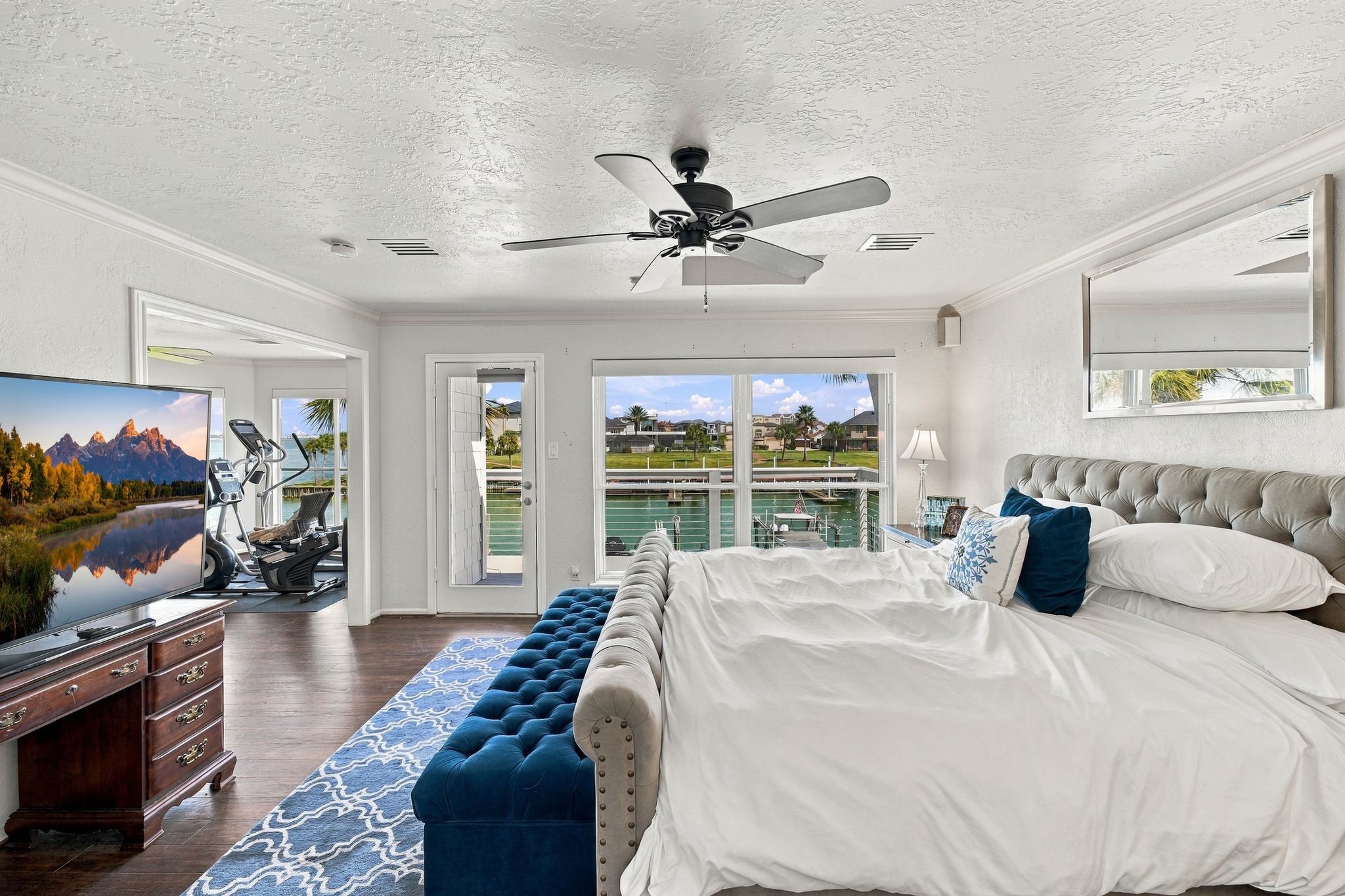 Glass doors in the primary bedroom open to a private balcony.