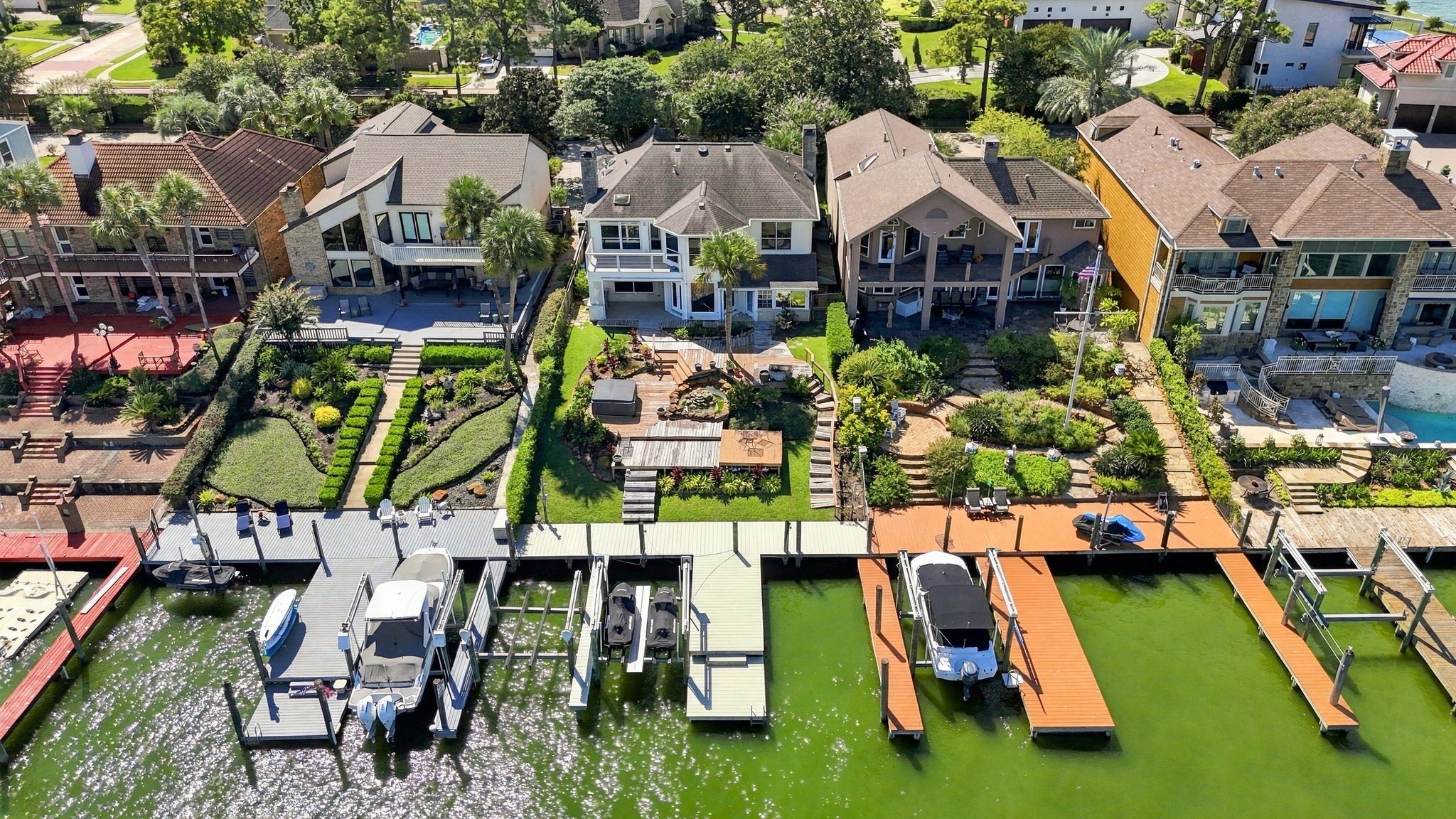 An overhead view shows the private boat dock and waterfront decking.