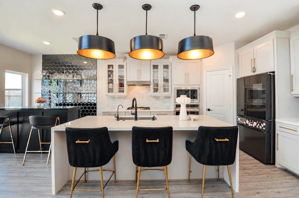 Elegant kitchen with a spacious island, stylish black pendant lights, and luxurious bar seating. Features modern appliances, a sleek black hexagonal tile backsplash, and a convenient built-in bar area. Elegant kitchen with a spacious island, stylish black pendant lights, and luxurious bar seating. Features modern appliances, a sleek black hexagonal tile backsplash, and a convenient built-in bar area.
