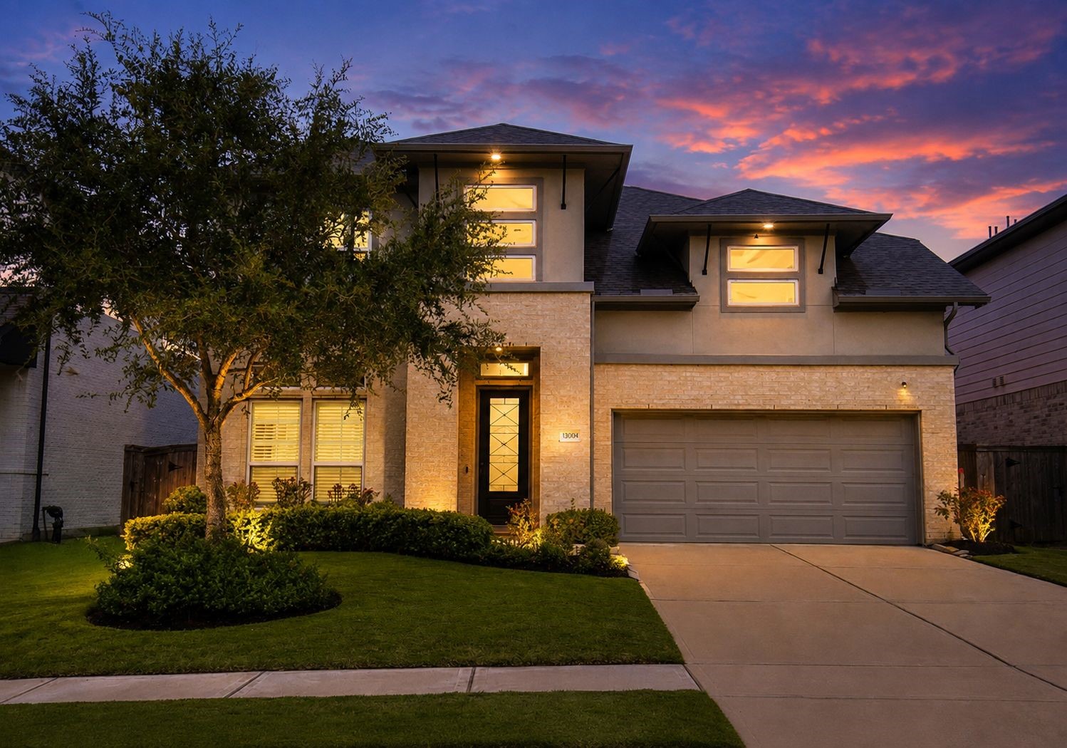 Stunning two-story home with modern architecture, beautifully lit against a vibrant sunset. Features a spacious two-car garage, manicured lawn, and inviting entryway. Stunning two-story home with modern architecture, beautifully lit against a vibrant sunset. Features a spacious two-car garage, manicured lawn, and inviting entryway.