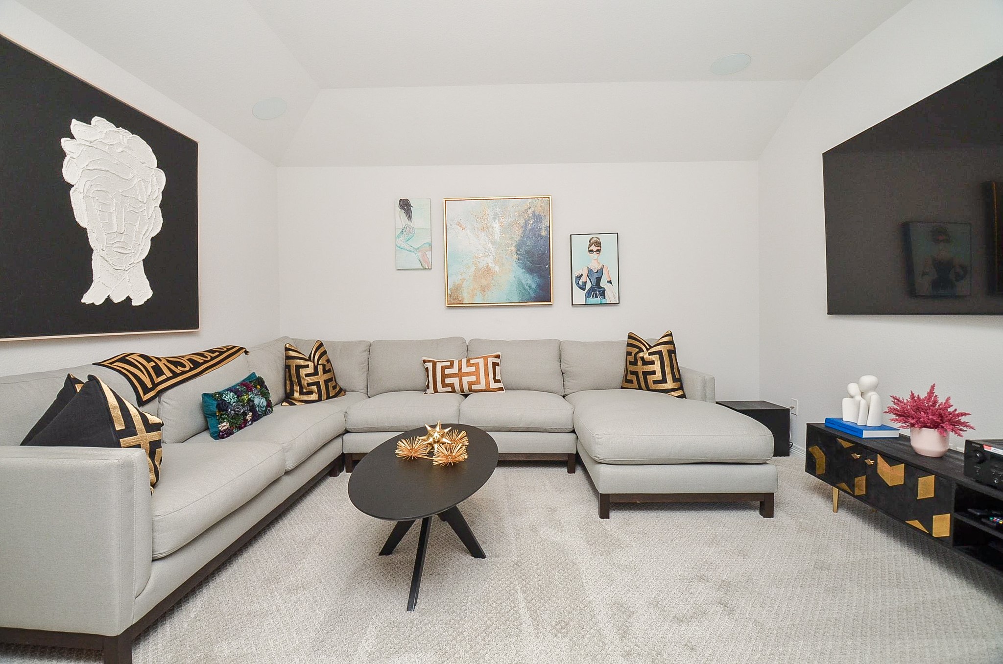 Stylish living room with a modern sectional sofa, chic black coffee table, and vibrant artwork, creating a cozy yet sophisticated ambiance.