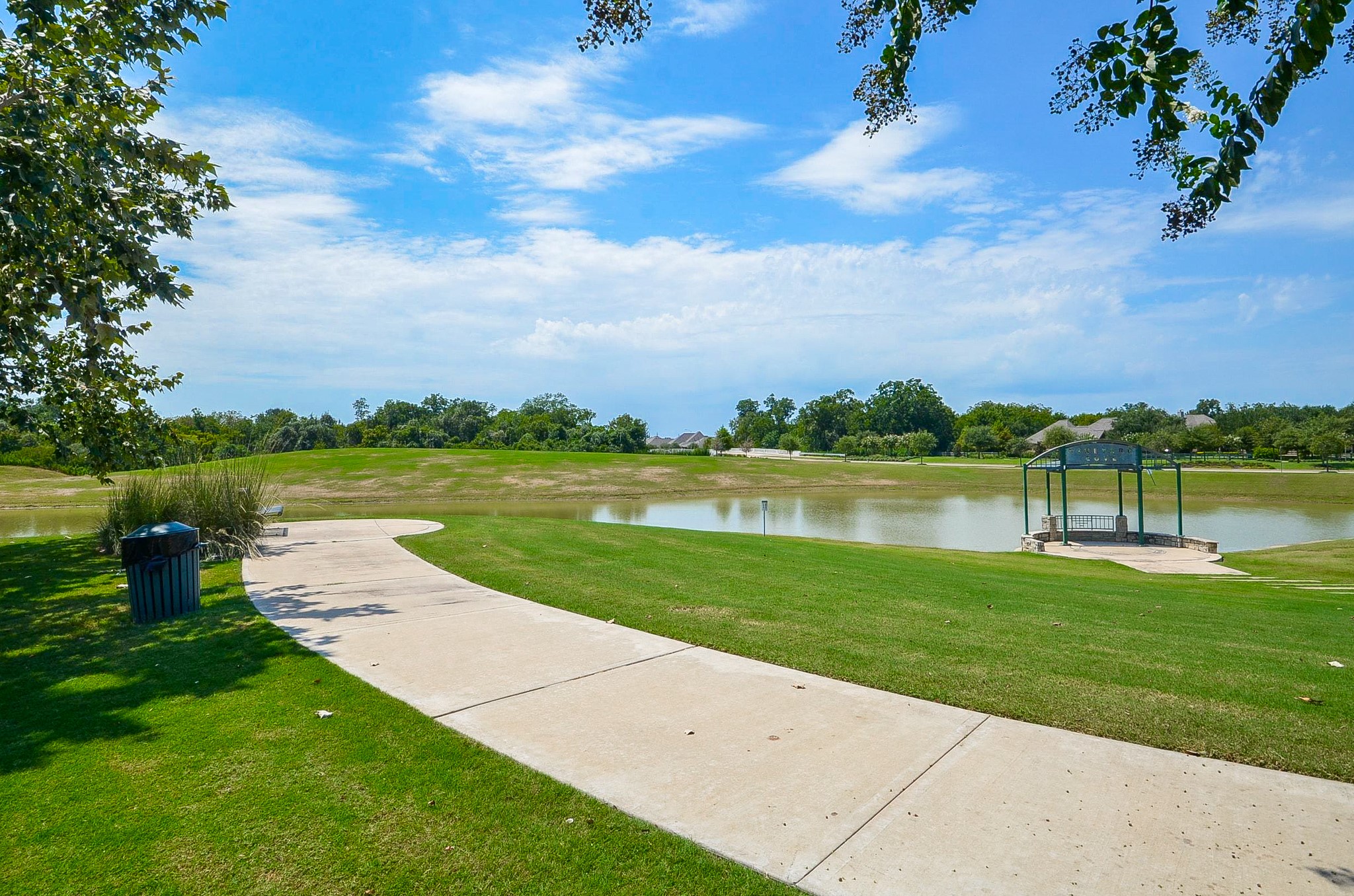 Scenic pathway alongside a tranquil pond, perfect for leisurely walks and enjoying nature.