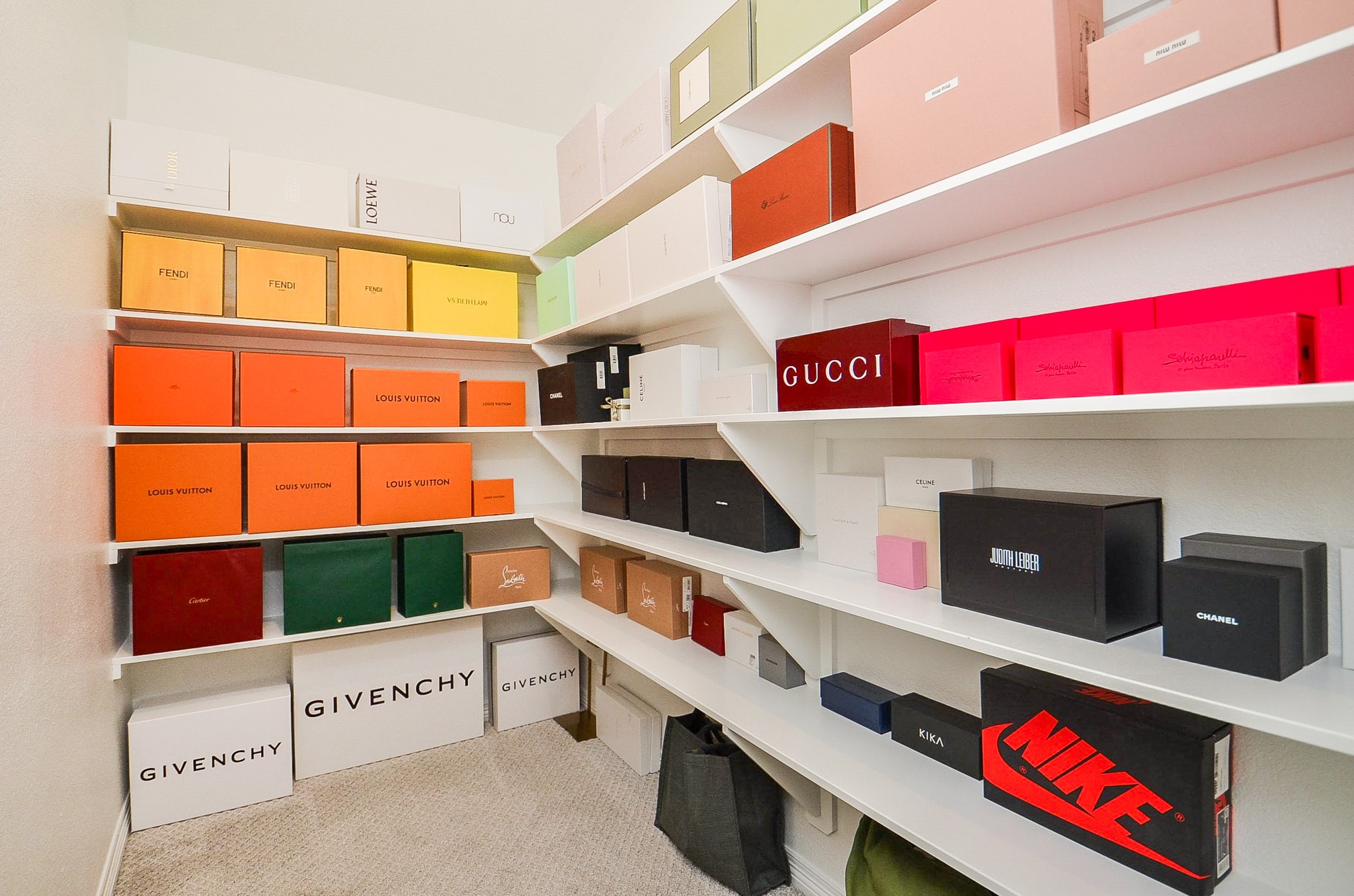 Spacious walk-in closet with custom shelving, perfect for organizing luxury items.