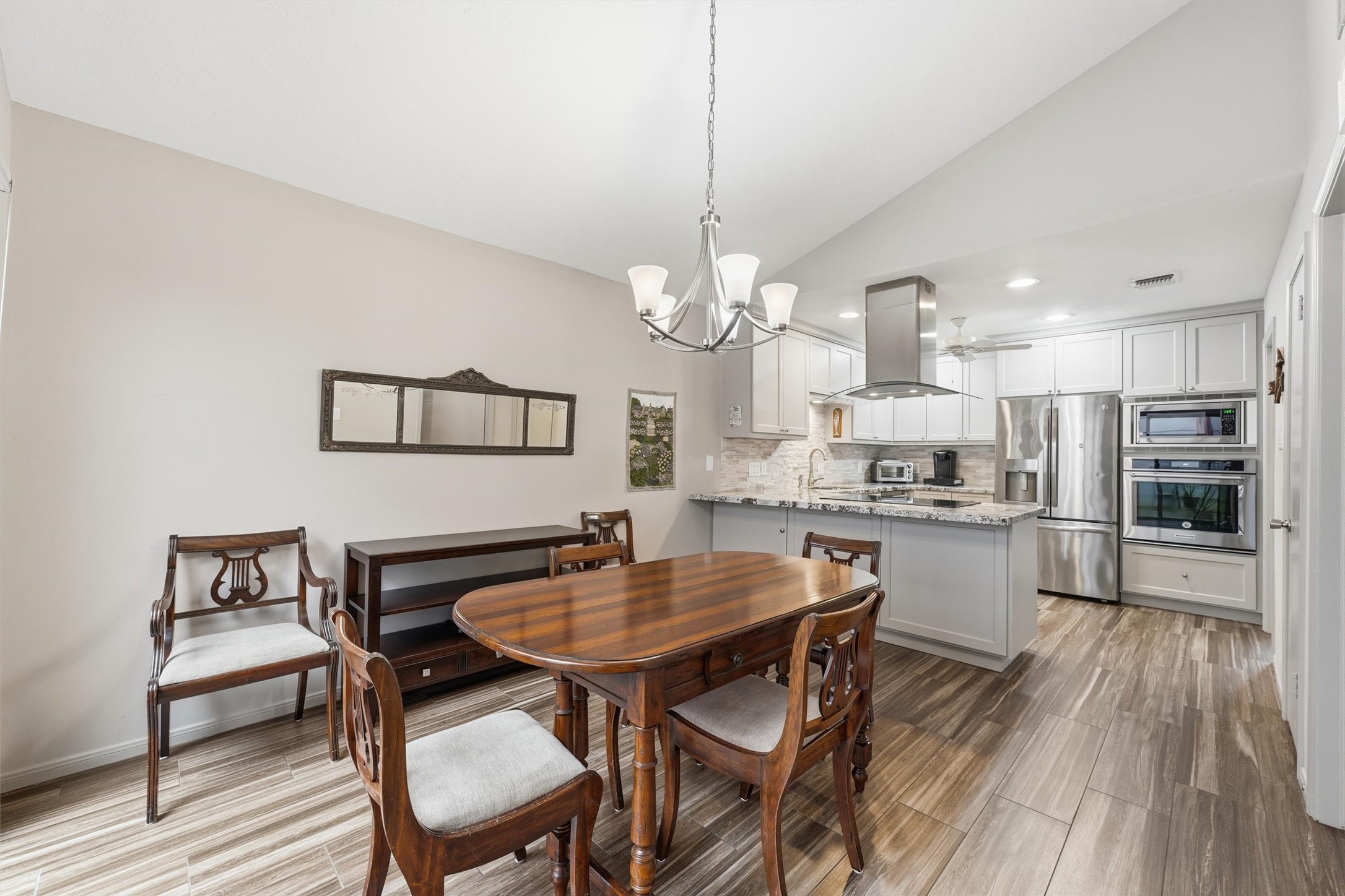 Pretty light filled dining area with upgraded light fixture.