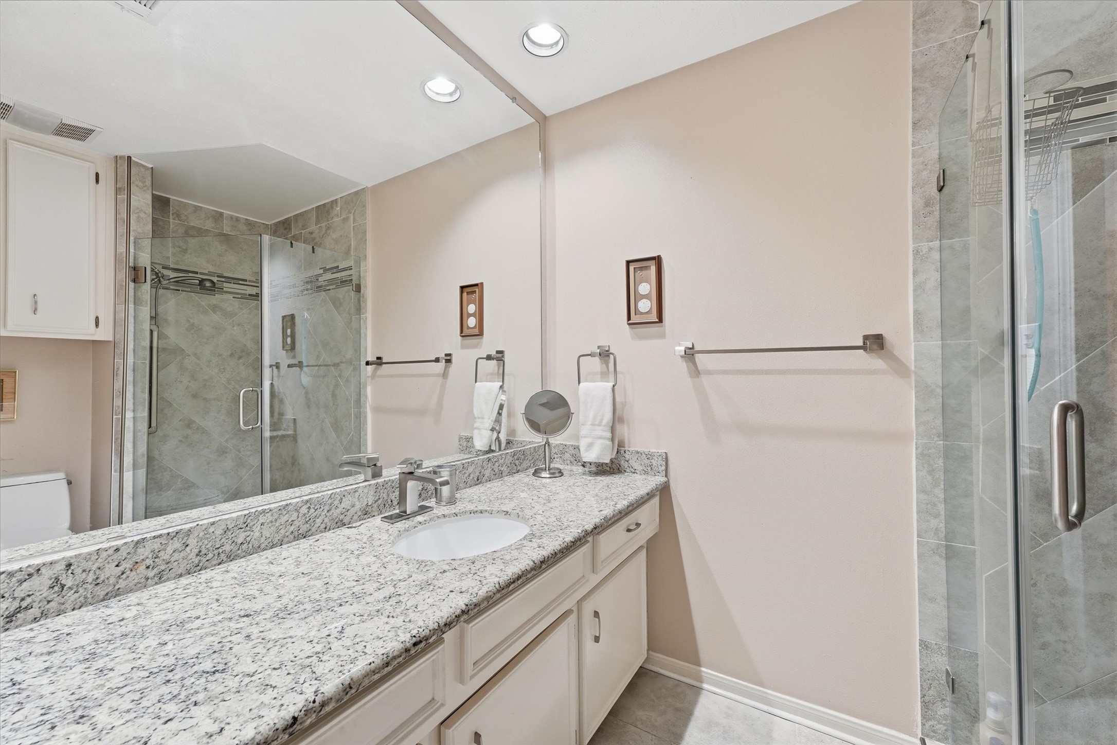 Some primary bath updates include granite counter, undermount sink, & tile floor.