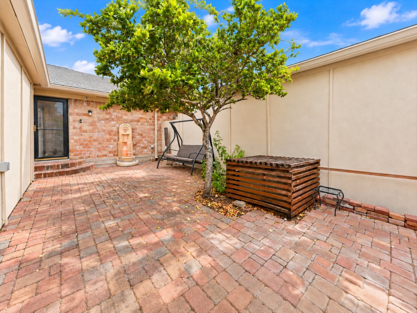 View of the back patio from the gate to the back door! 54 T Huxley not only has a spacious atrium, it also has one of the larger back patio areas in the neighborhood.