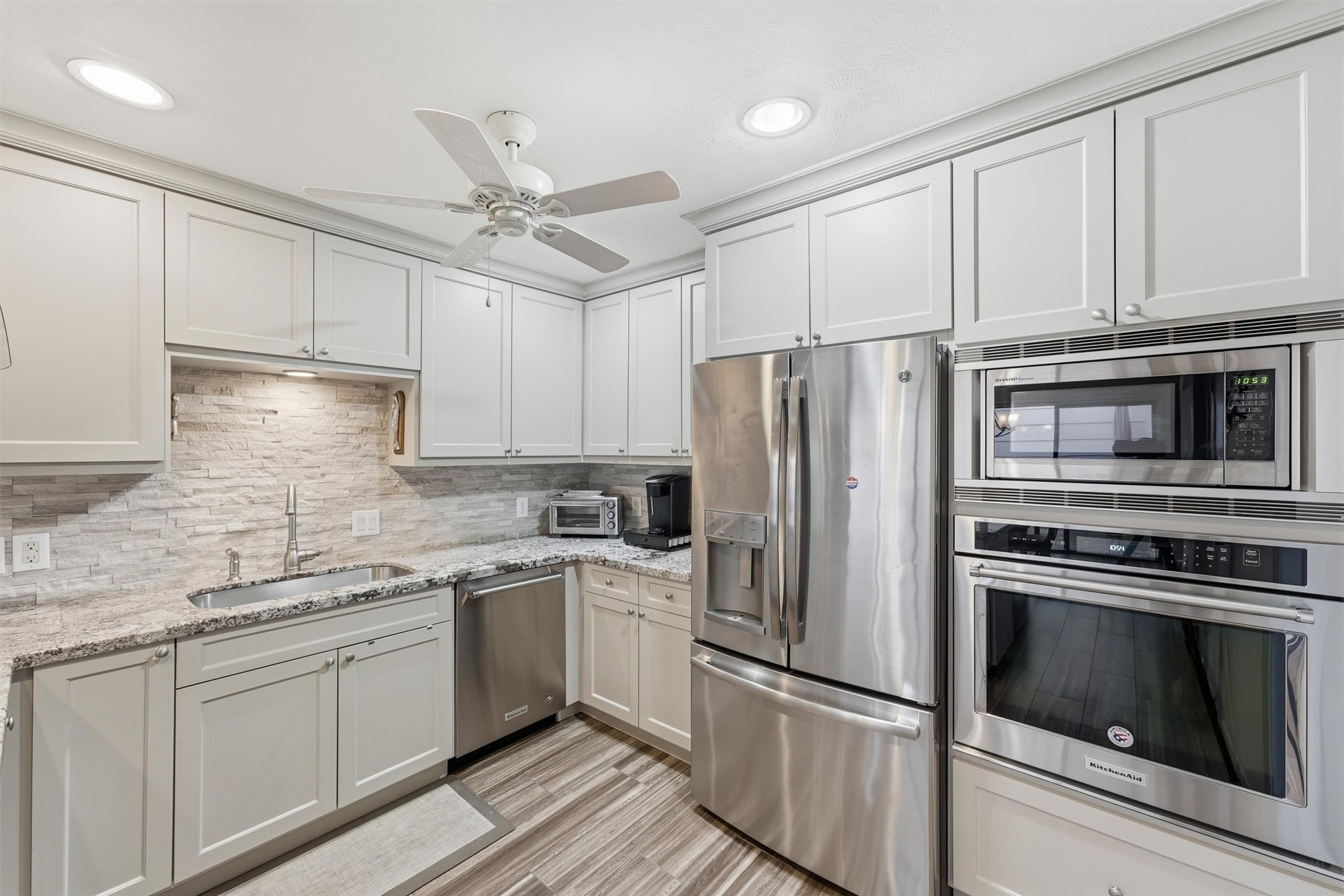 Kitchen is a dream with plenty of counter & cabinet space, KitchenAid oven & dishwasher, large undermount sink, neutral tile backsplash & more! Kitchen is a dream with plenty of counter & cabinet space, KitchenAid oven & dishwasher, large undermount sink, neutral tile backsplash & more!