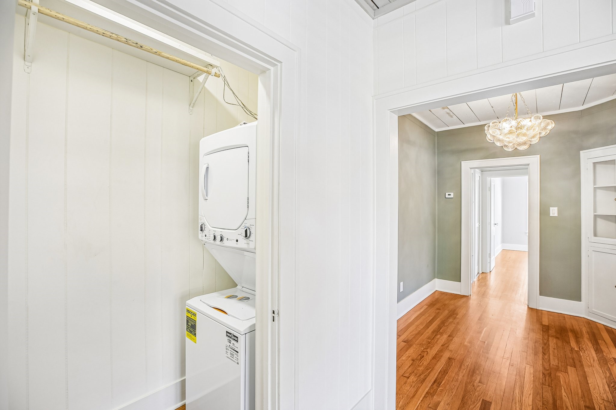 Here is the utility closet with a brand new stackable washer and dryer. There is also hanging and upper shelf storage.