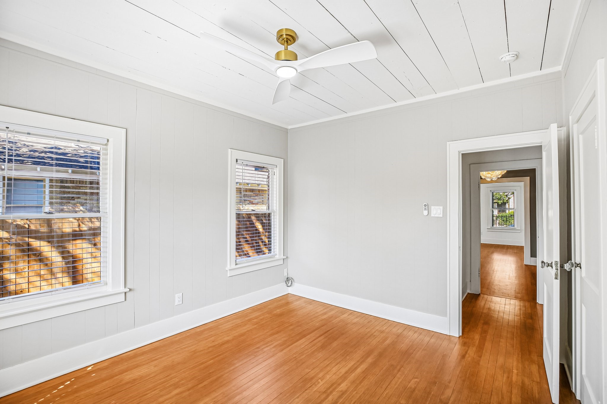 The bedroom is off of the hallway and away from the main living area.
