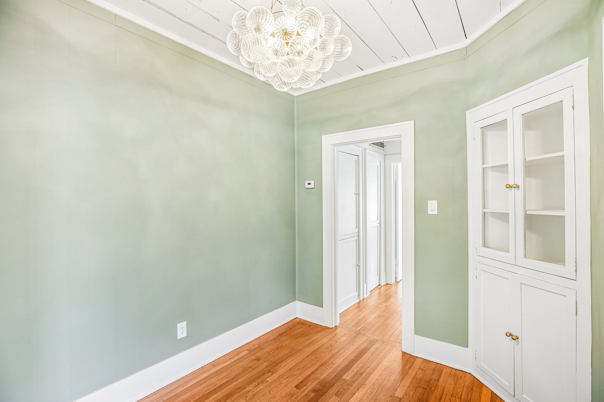The dining room flows into the hallway ahead.