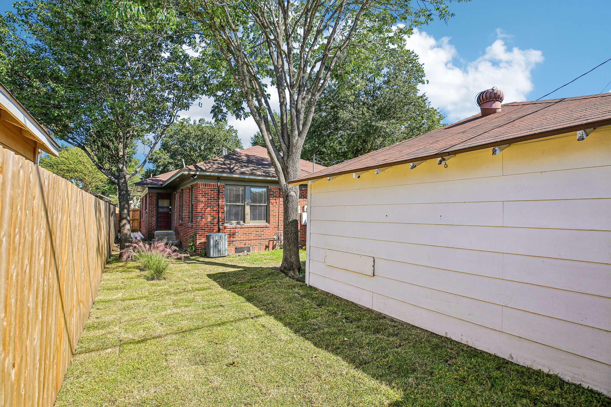 The private yard is accessible through a gate at the driveway and from the kitchen door in the house.