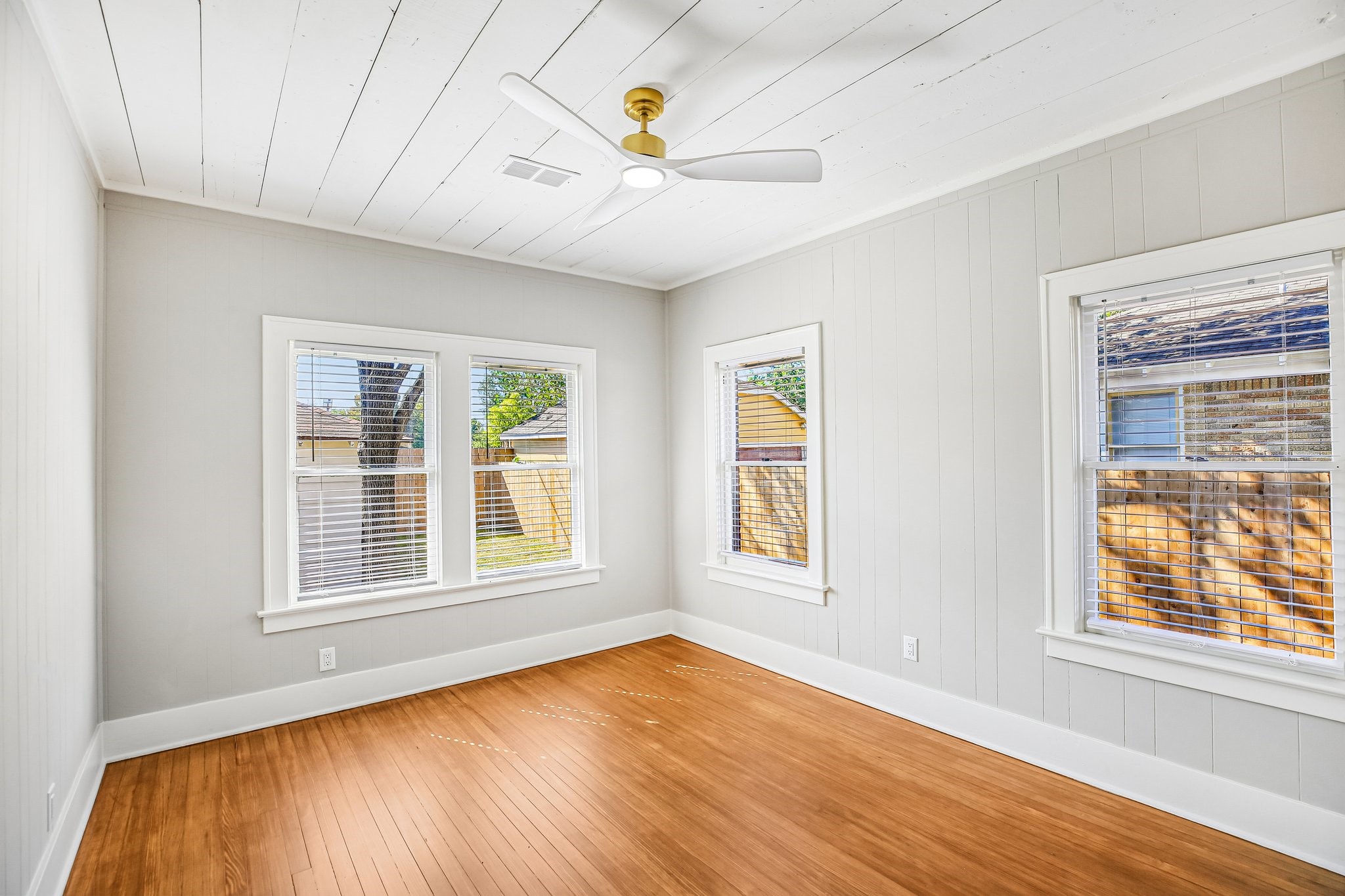 The bedroom features reverse paint from the living room and the same stylish ceiling fan.