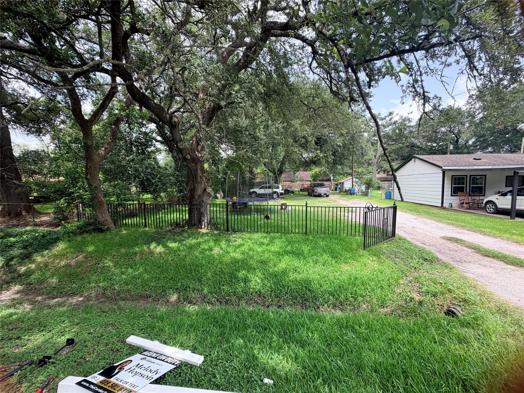 Another view of the property showcases the generous lot dimensions and the surrounding residential homes.