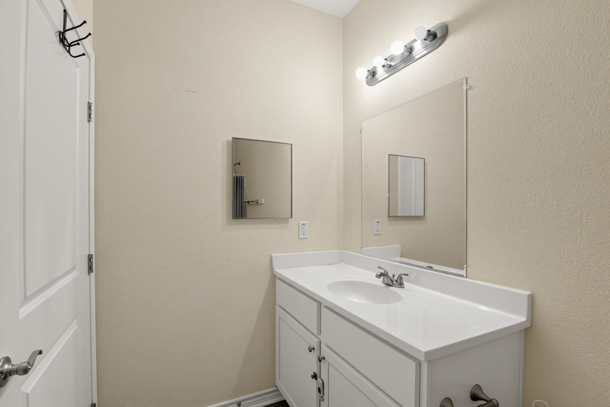 Bathroom vanity with an integrated cultured marble sink.