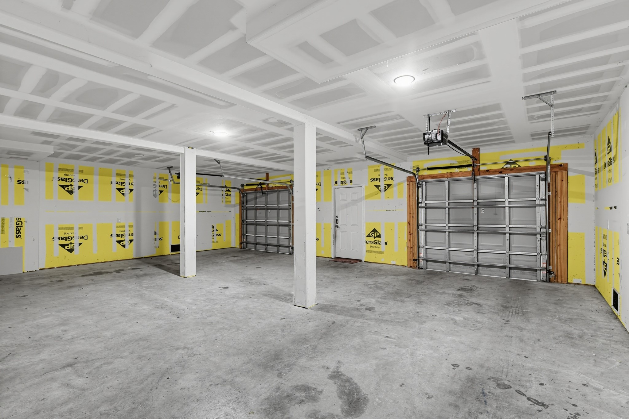 Finished two-car garage with extra storage space. The three-car-wide layout offers plenty of room.