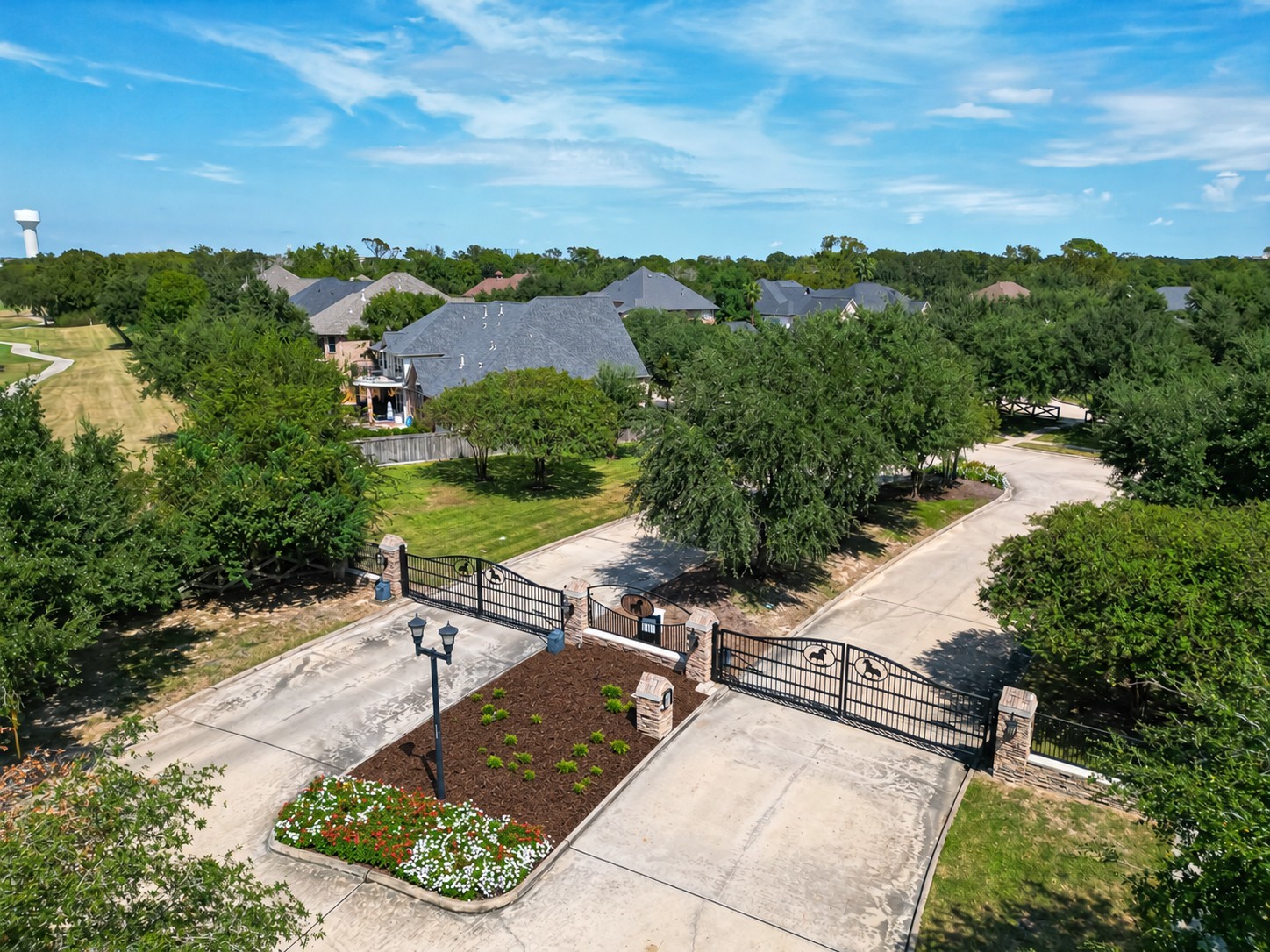 Gated entrance to a serene residential community, featuring lush greenery and well-maintained landscaping, offering privacy and a welcoming atmosphere. Gated entrance to a serene residential community, featuring lush greenery and well-maintained landscaping, offering privacy and a welcoming atmosphere.