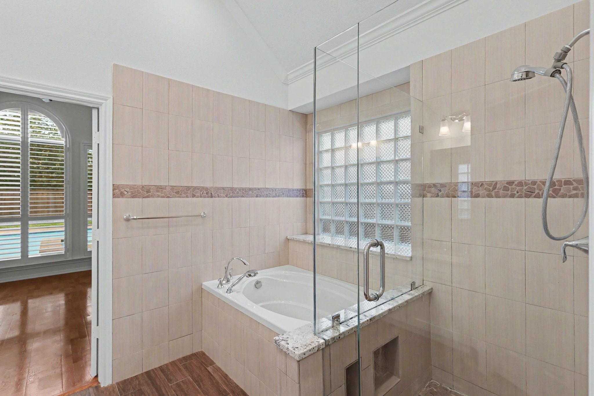 Walk-in shower and separate tub in primary bath.