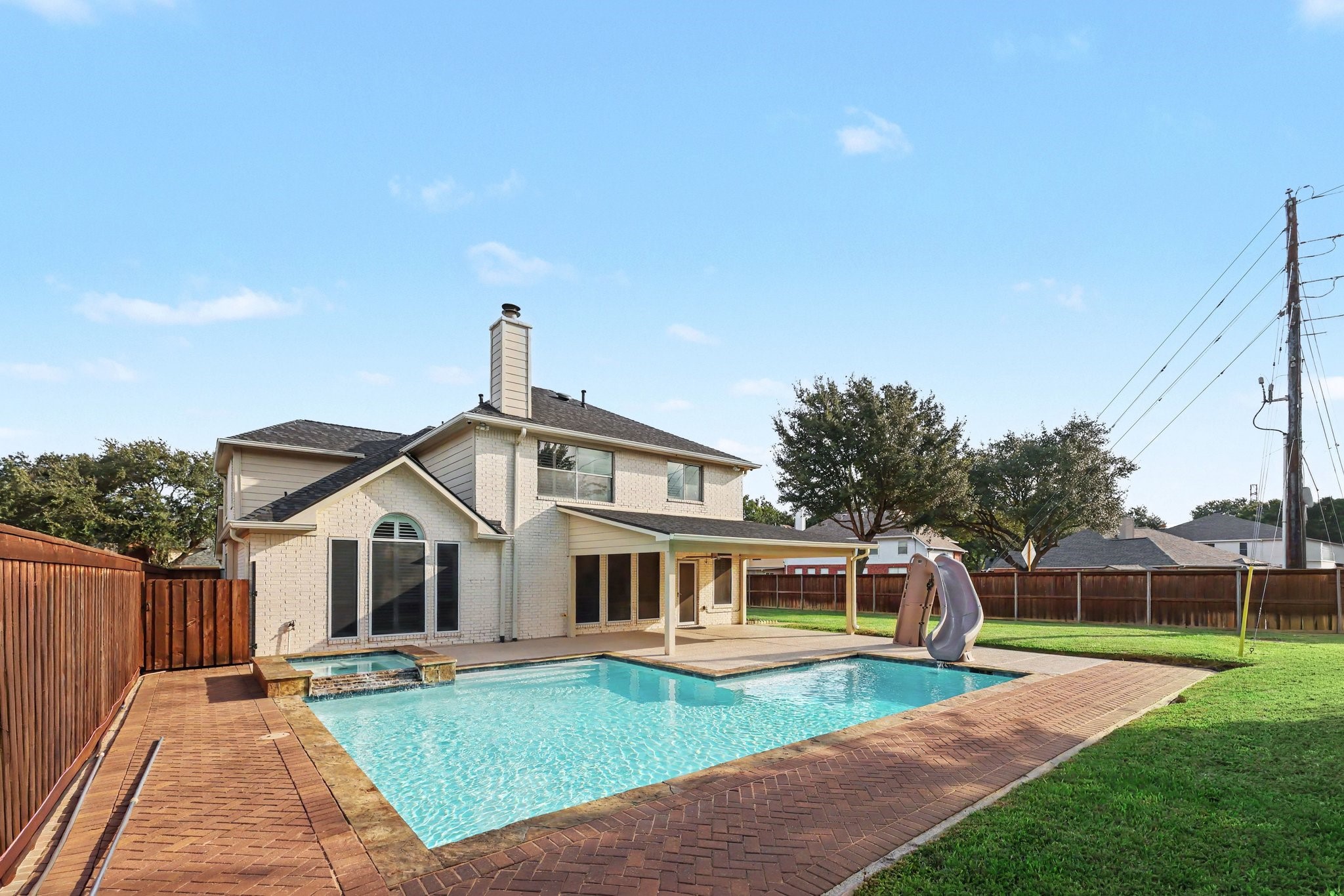 Large backyard space with pool & hot tub.