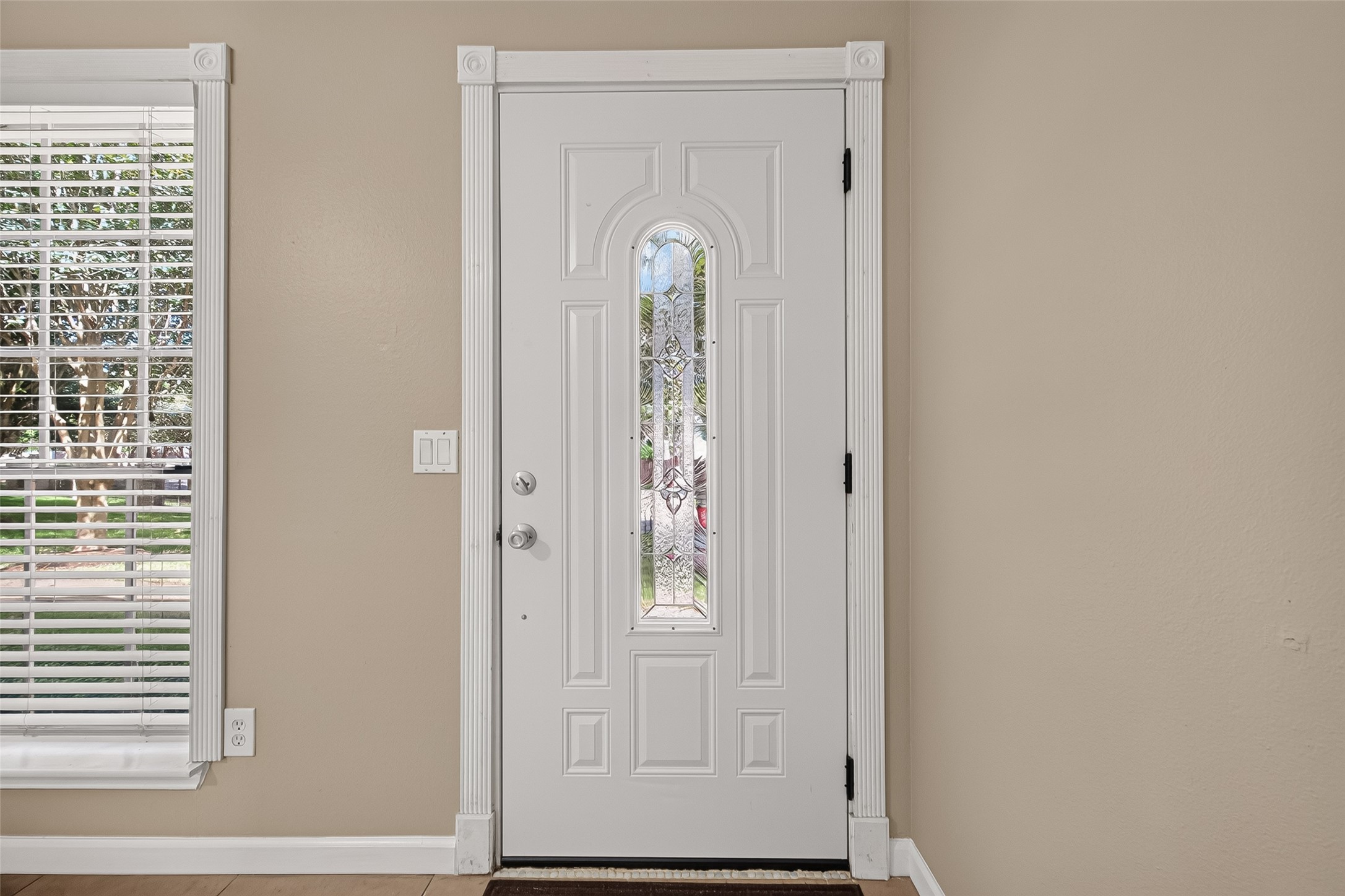 Bright entry featuring a decorative glass front door, neutral finishes, and natural light. Bright entry featuring a decorative glass front door, neutral finishes, and natural light.
