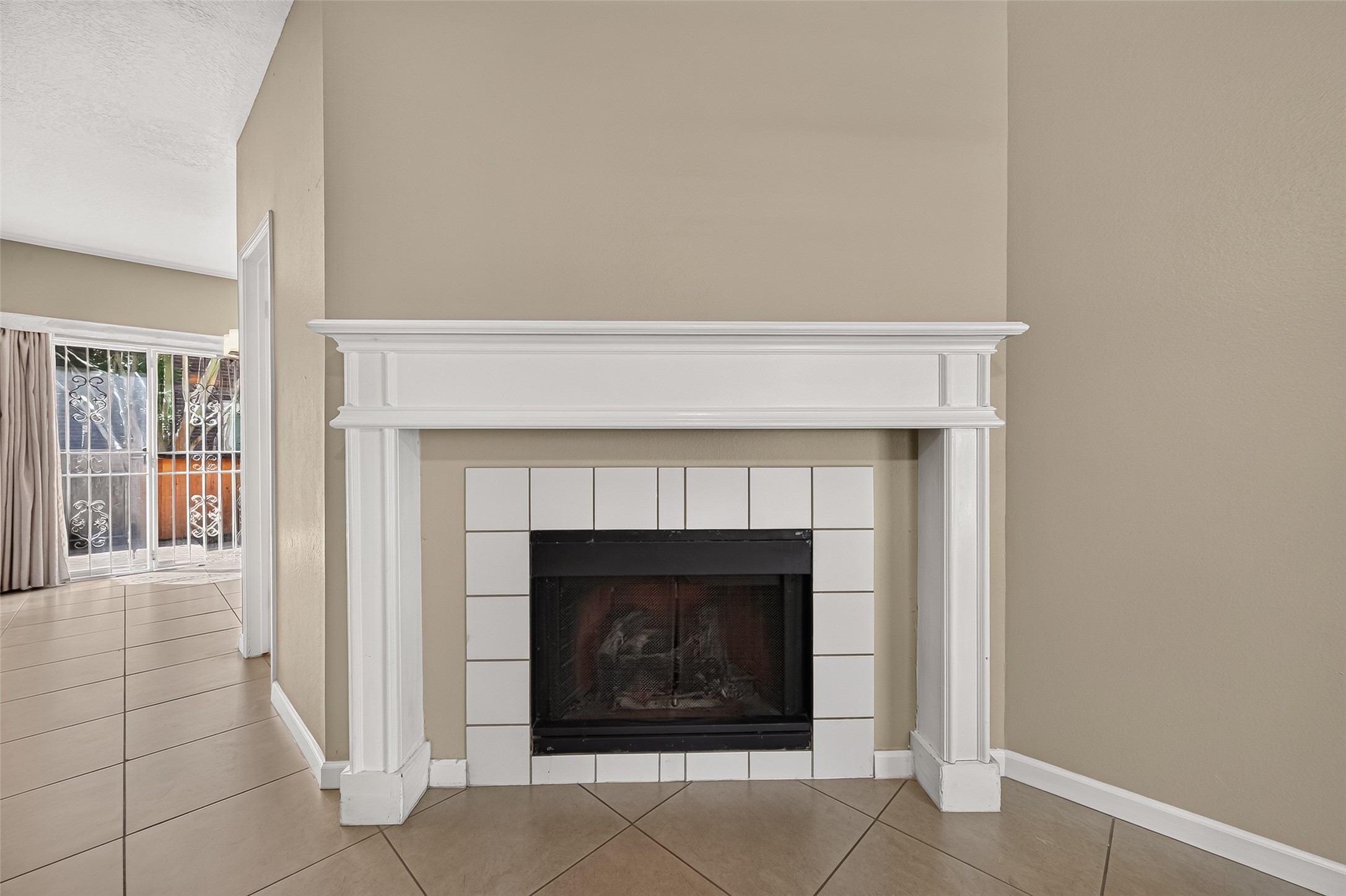 Attractive fireplace with classic white mantel and tile surround creates a warm focal point for the living area. Attractive fireplace with classic white mantel and tile surround creates a warm focal point for the living area.