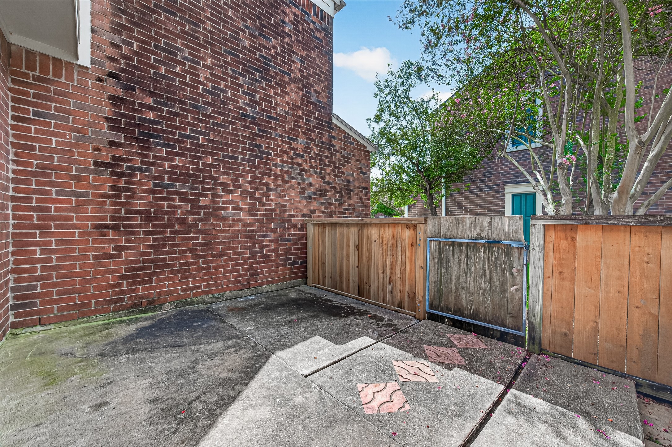 Low-maintenance outdoor space enclosed by privacy fencing, providing a convenient area for outdoor seating and everyday enjoyment.