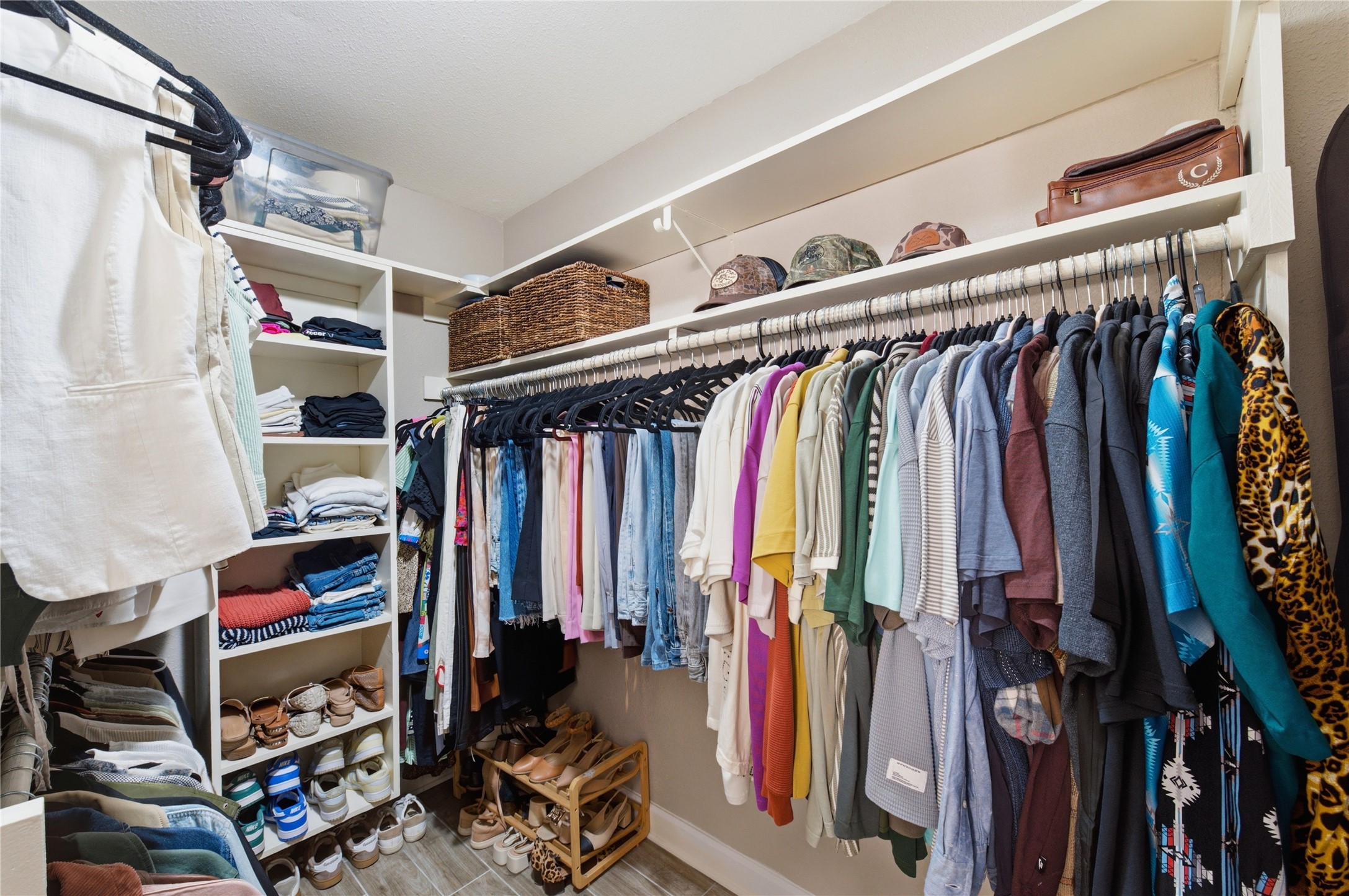 Generously sized primary walk-in closet with ample storage.